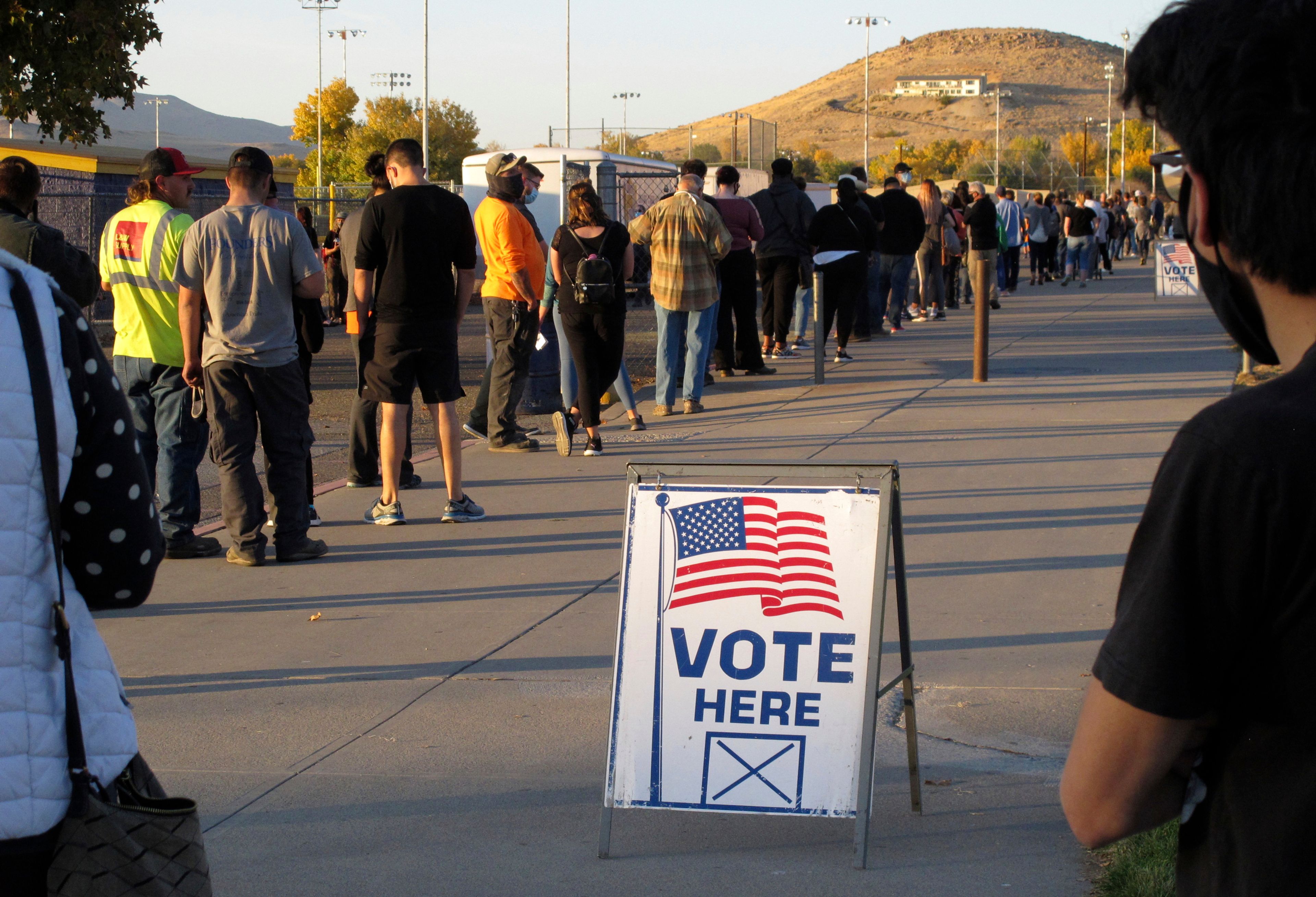 FILE - People wait to vote in-person at Reed High School in Sparks, Nev., prior to polls closing on Nov. 3, 2020. (AP Photo/Scott Sonner, File)