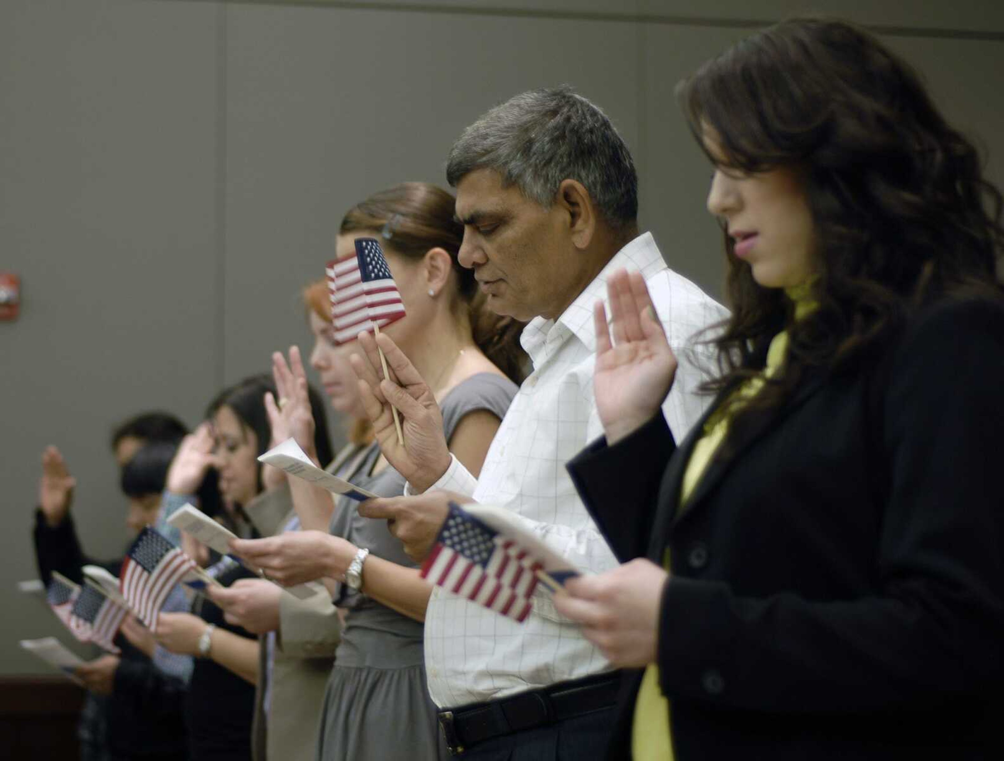 Eighteen new U.S. citizens pledge their Oath of Allegiance during the naturalization ceremony Monday at the Rush H. Limbaugh Sr. U.S. Courthouse in Cape Girardeau. (Bob Miller)