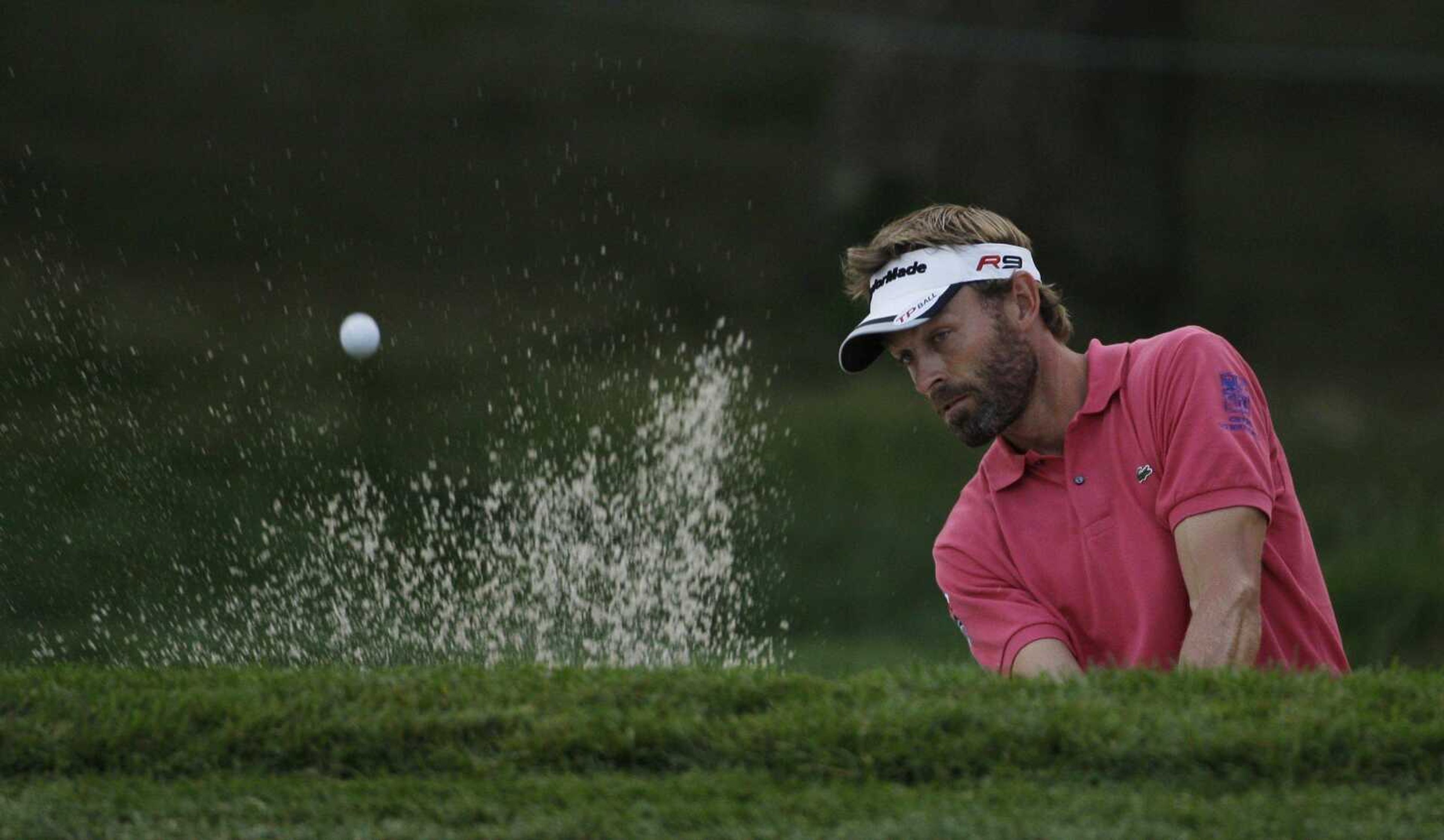 Raphael Jacquelin of France blasts out of a bunker on the seventh hole Friday during the second round of the U.S. Open at Bethpage State Park's Black Course in Farmingdale, N.Y. After heavy rain suspended Thursday's first round, players completed their opening 18 holes Friday before starting on their second rounds. (MEL EVANS ~ Associated Press)