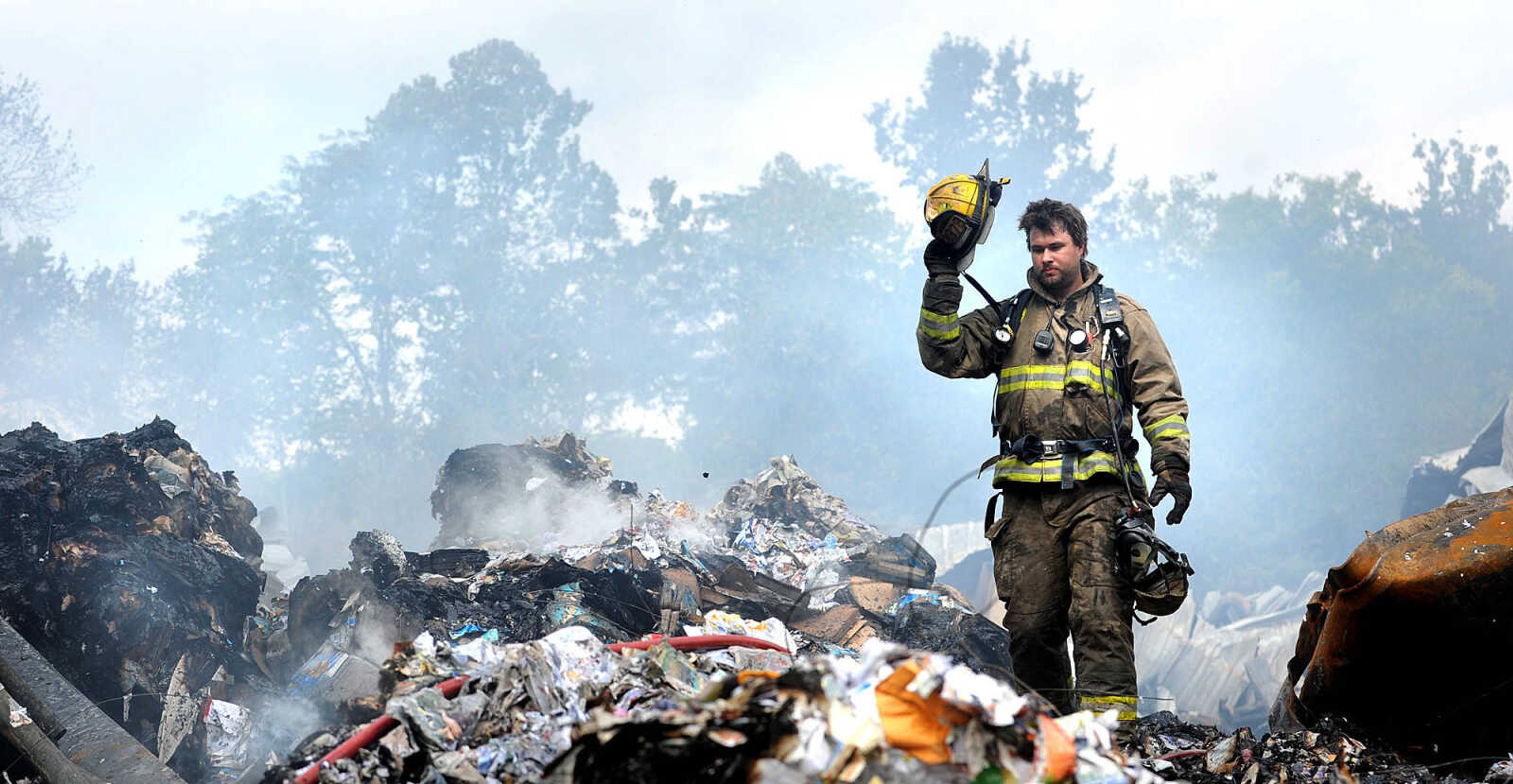 LAURA SIMON ~ lsimon@semissourian.com

David Goehman with the East County Fire Protection District walks through the smoldering ruble of the Missouri Plastics plant Friday morning, Oct. 4, 2013, in Jackson. The approximately 100,00-square-foot recycling plant caught fire around 10 p.m. Thursday. Every fire department in Cape Girardeau County was dispatched to battle the blaze.