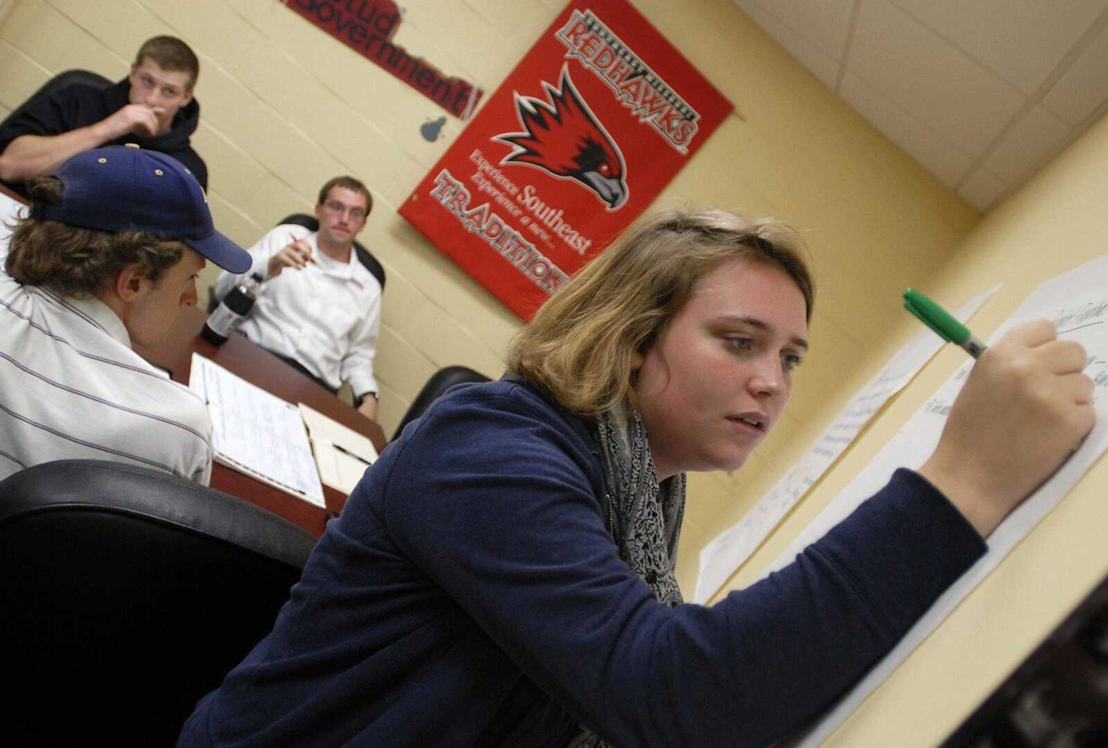 Southeast Missouri State University student government president Katie Herring, right, writes down ideas on a poster during a committee meeting Thursday to discuss ways of getting student feedback on a possible fee increase. Various government senators attended the meeting, including first-year senator Greg Felock, upper left, Daniel Schuenemeyer, Harrison College of Business senator, right, and Michael McKeever, bottom left, College of Education senator. (Kristin Eberts)