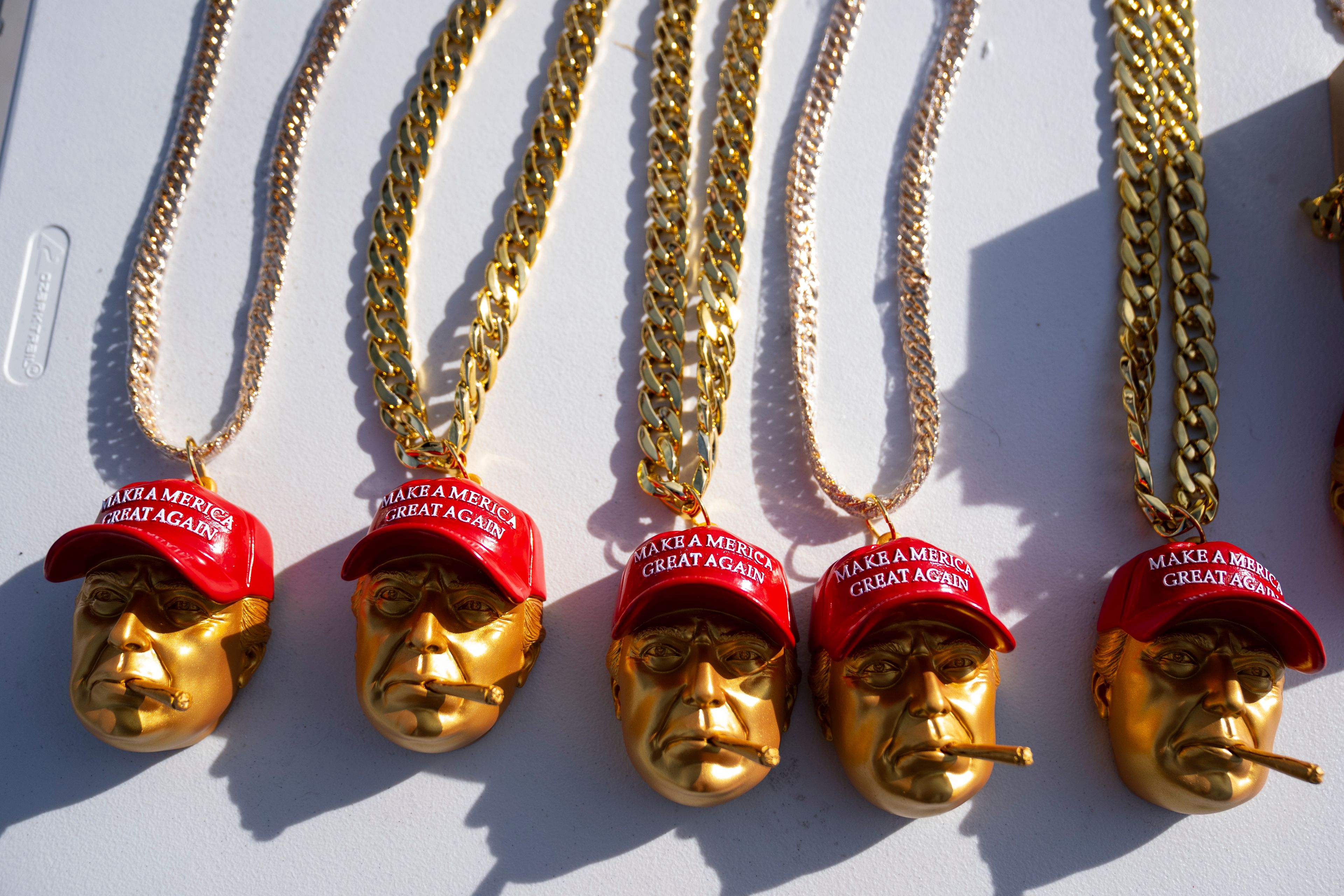 Merchandise for sale sits on a table outside a campaign rally for Republican presidential nominee former President Donald Trump at Lee's Family Forum, Thursday, Oct. 31, 2024, in Henderson, Nev. (AP Photo/Evan Vucci)