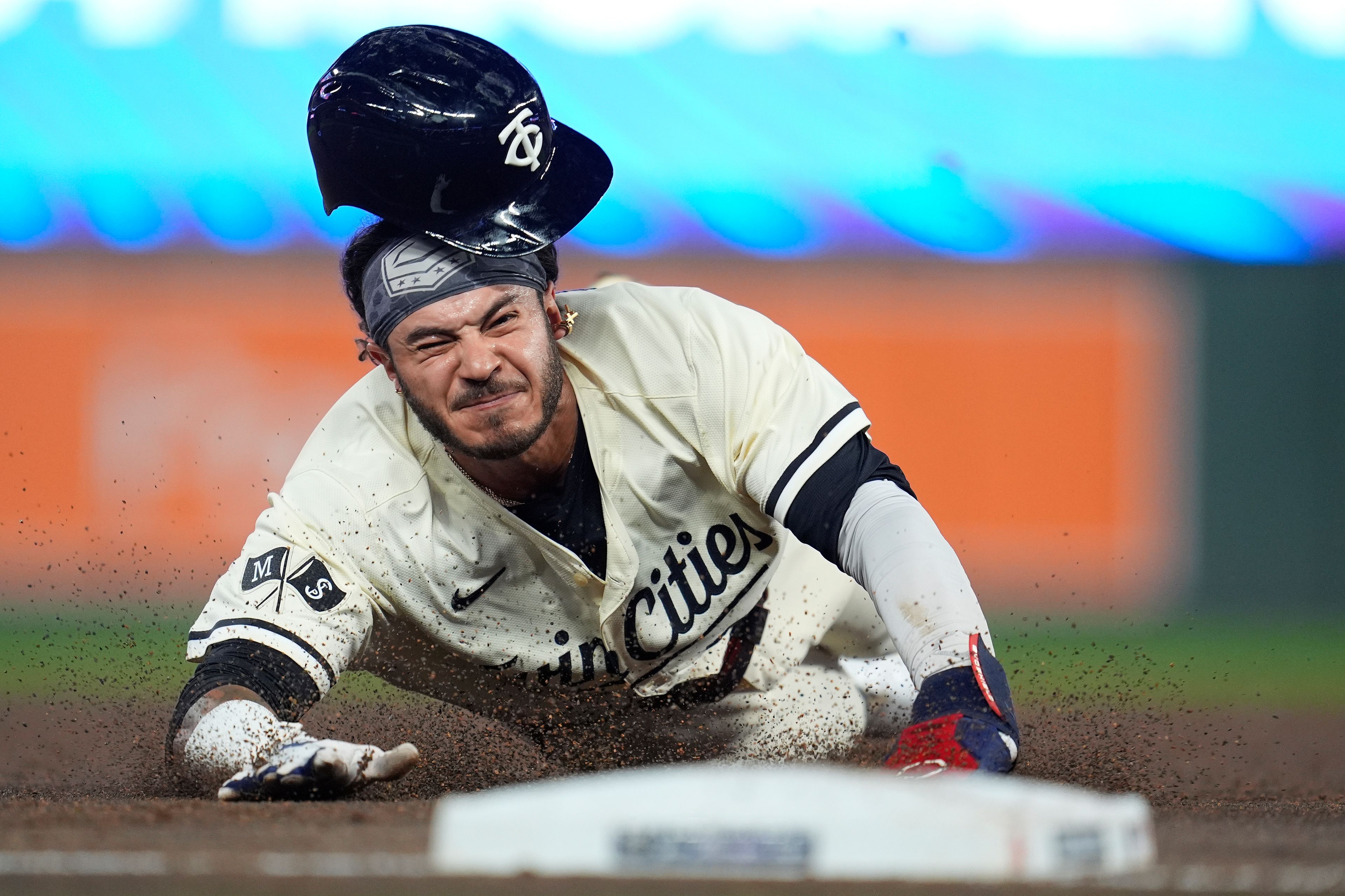 Minnesota Twins' Austin Martin slides into third base after a single hit by teammate Carlos Correa during the third inning of a baseball game against the Miami Marlins, Thursday, Sept. 26, 2024, in Minneapolis. (AP Photo/Abbie Parr)