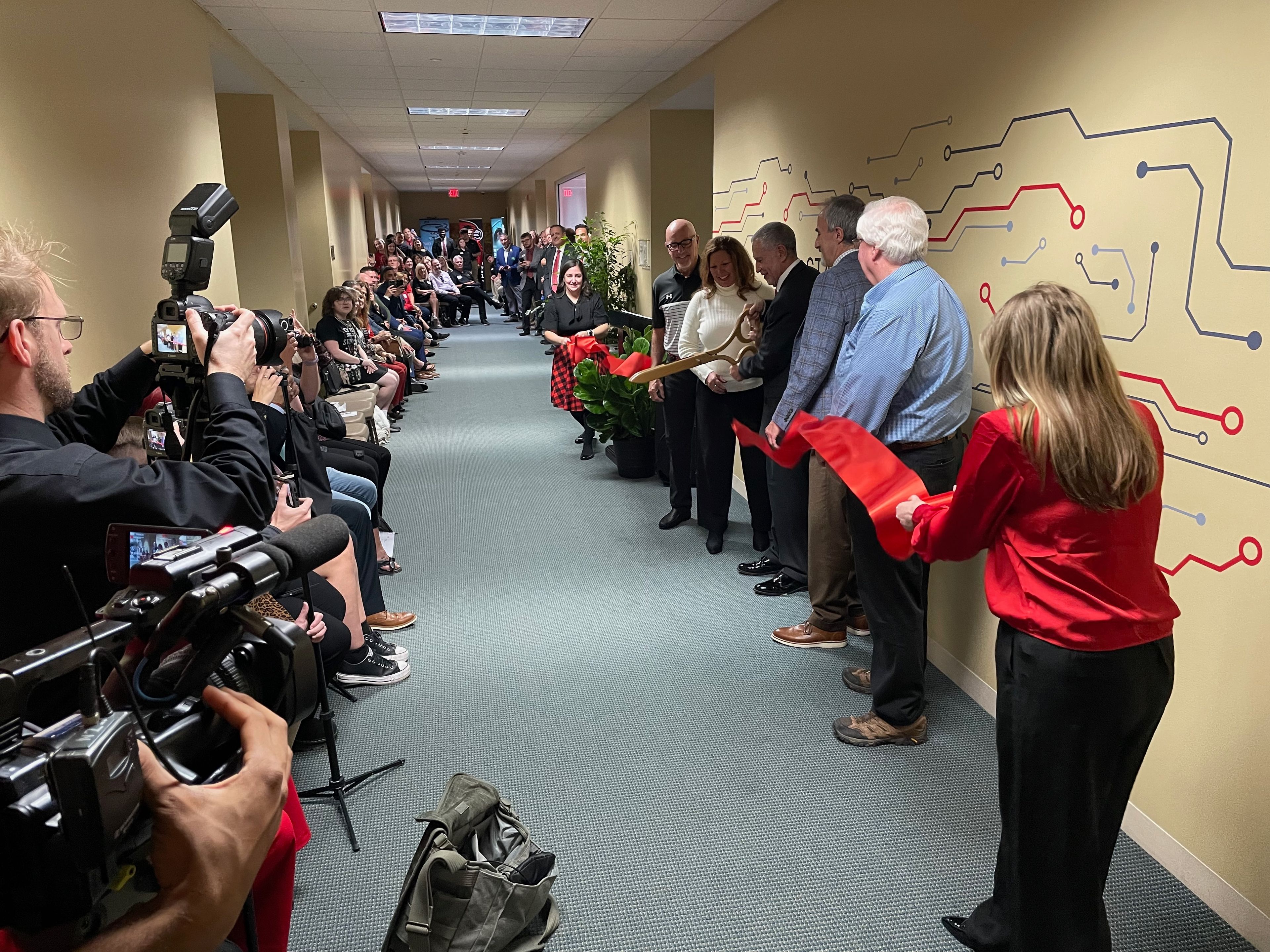 Officials from Southeast Missouri State University, including members of the Board of Governors and representatives from IBM, officially cut the ribbon to open the Charles Stamp Cyber Command Center.