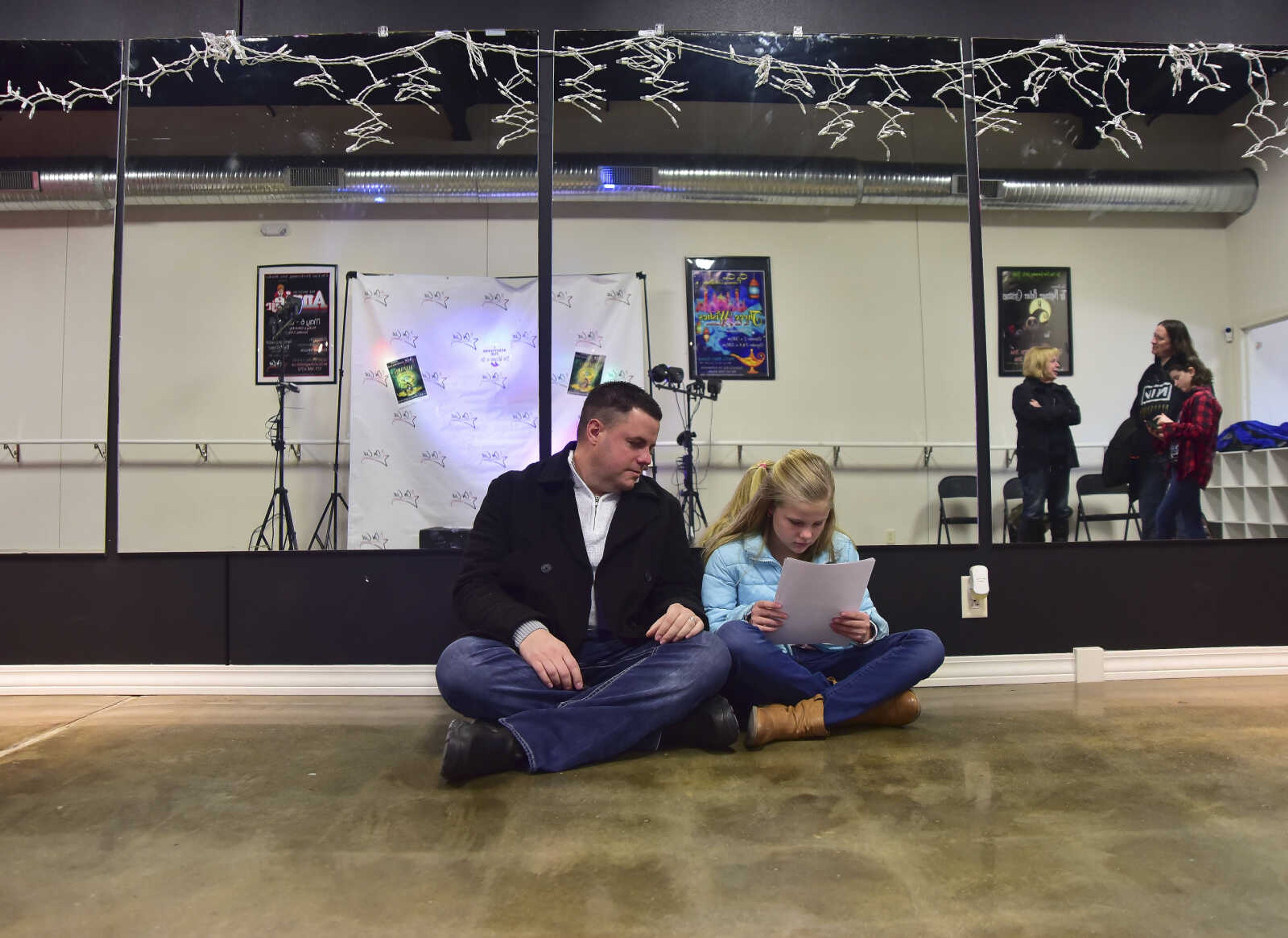 Steve Nickell, left, and Kyleigh Nickell, right, wait before auditioning for parts for the Wizard of Oz at On Cue Performing Arts Studio Saturday, Jan. 7, 2017 in Cape Girardeau.