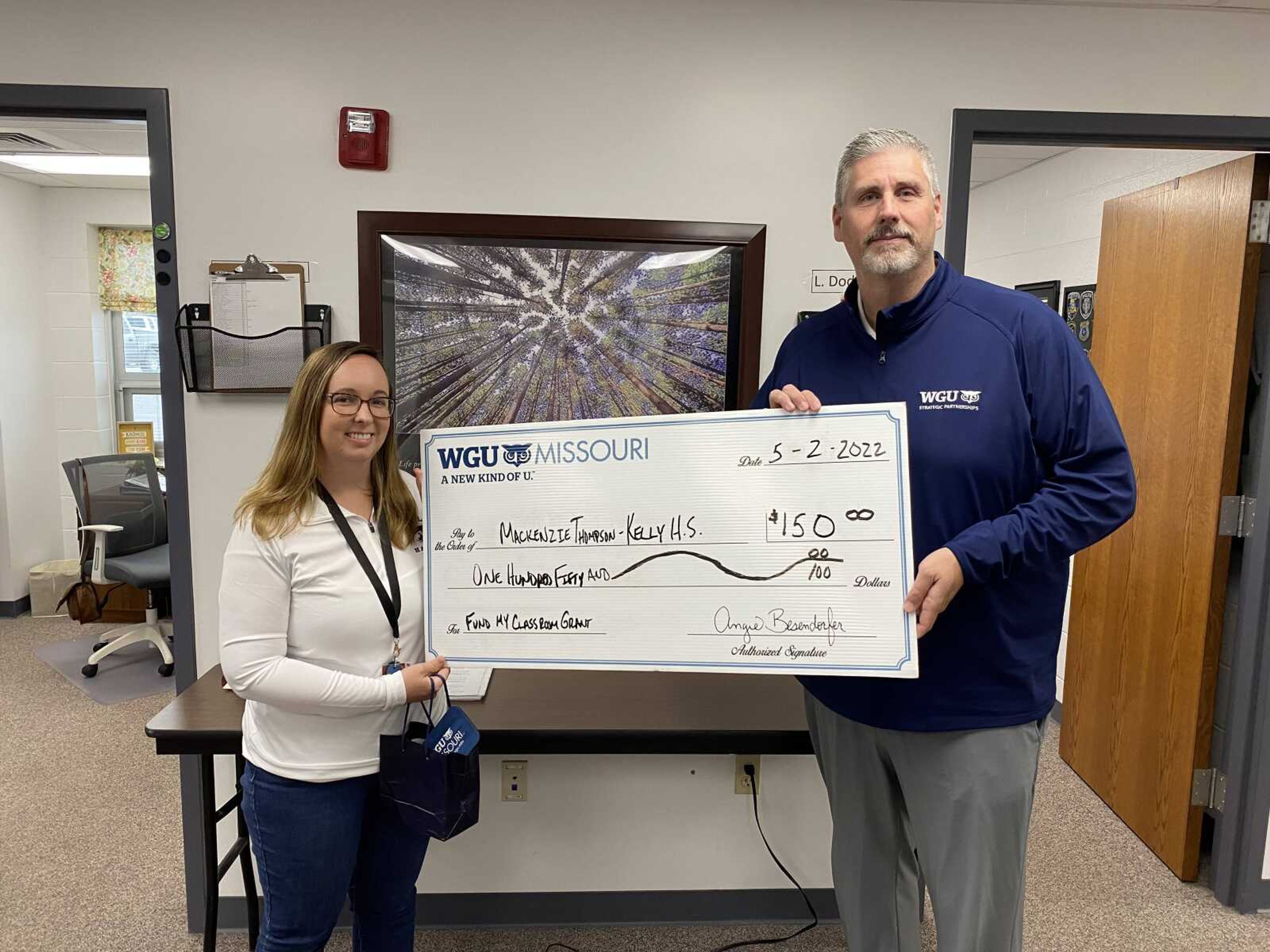 Mackenzie Thompson, an English Language Arts teacher at Thomas W. Kelly High School in the Scott County R-IV School District in Benton, poses with WGU Missouri Strategic Partnerships Manager Jim Chandler after learning she had been selected to receive a $150 grant for her classroom project.