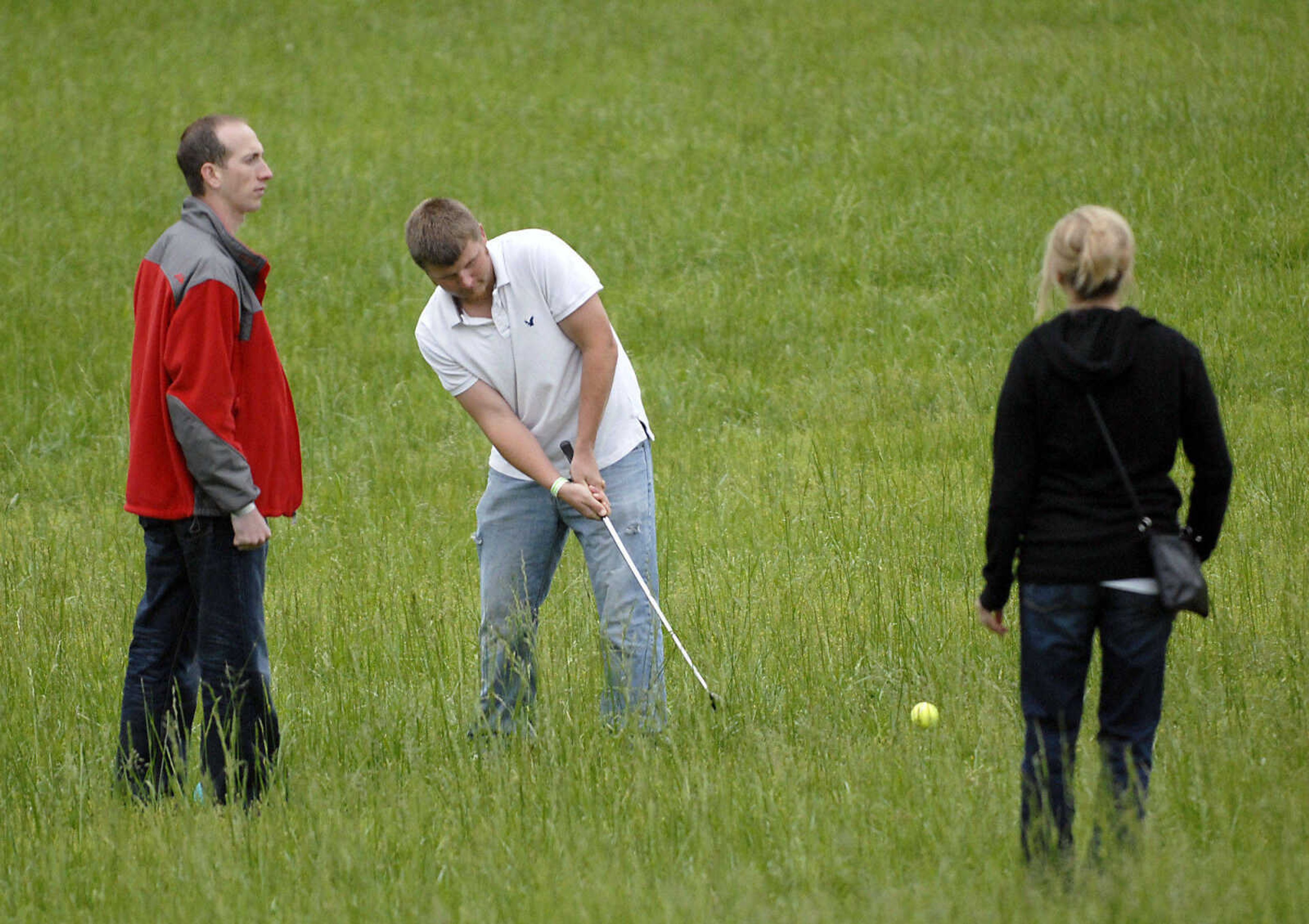 KRISTIN EBERTS ~ keberts@semissourian.com

Brandon Raithel, center, hits toward the green as teammates Corey and Melissa Rentfrow watch during the Kow Pasture Klassic at Schlinder's Tavern in New Hamburg, Mo., on Saturday, May 14, 2011. Proceeds from the event benefit the Kenny Rogers Children's Center and the Missouri Veterans Home.