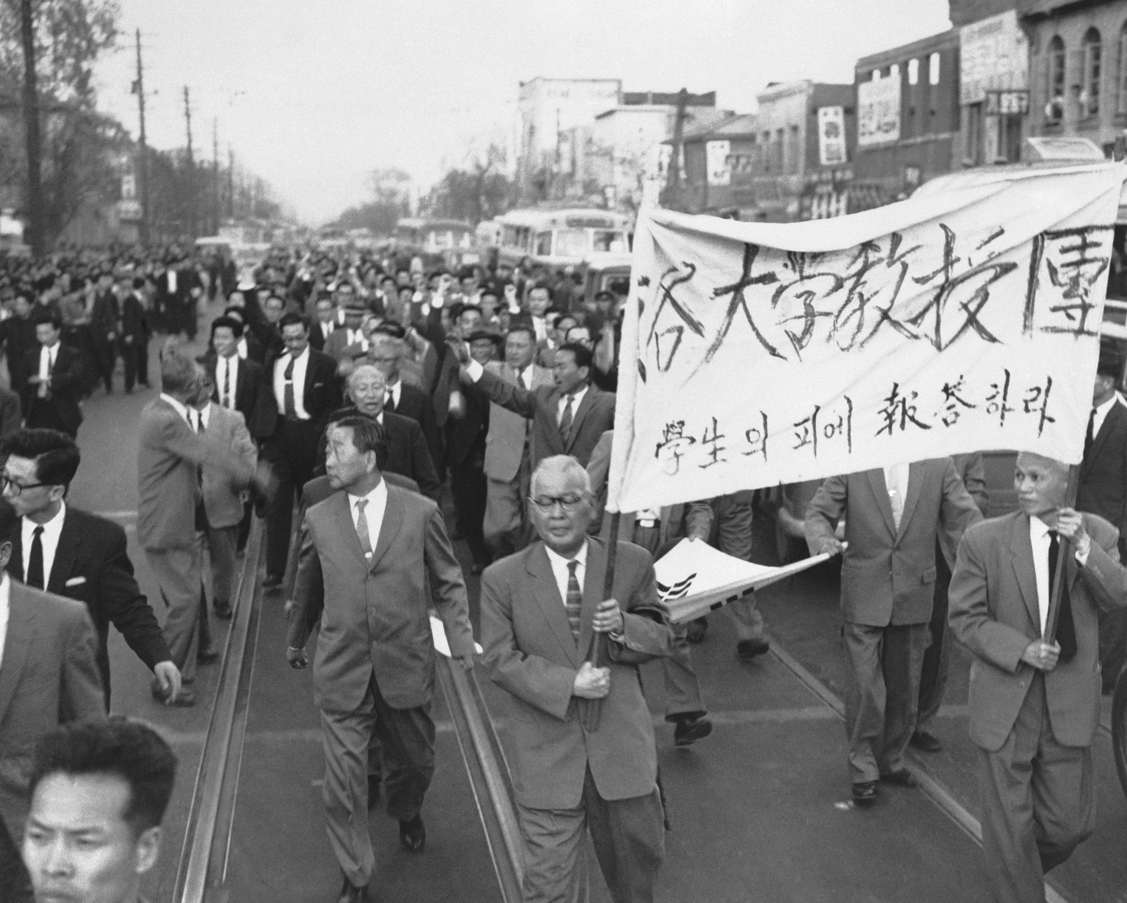 FILE- Some 200 college professors representing 27 colleges, march along a Seoul street, in South Korea, on April 25, 1960, after a meeting at the Seoul University. The professors expressed embarrassment that they had left it to their students to lead the movement against what they considered misrule by President Sungman Rhee. (AP Photo/File)