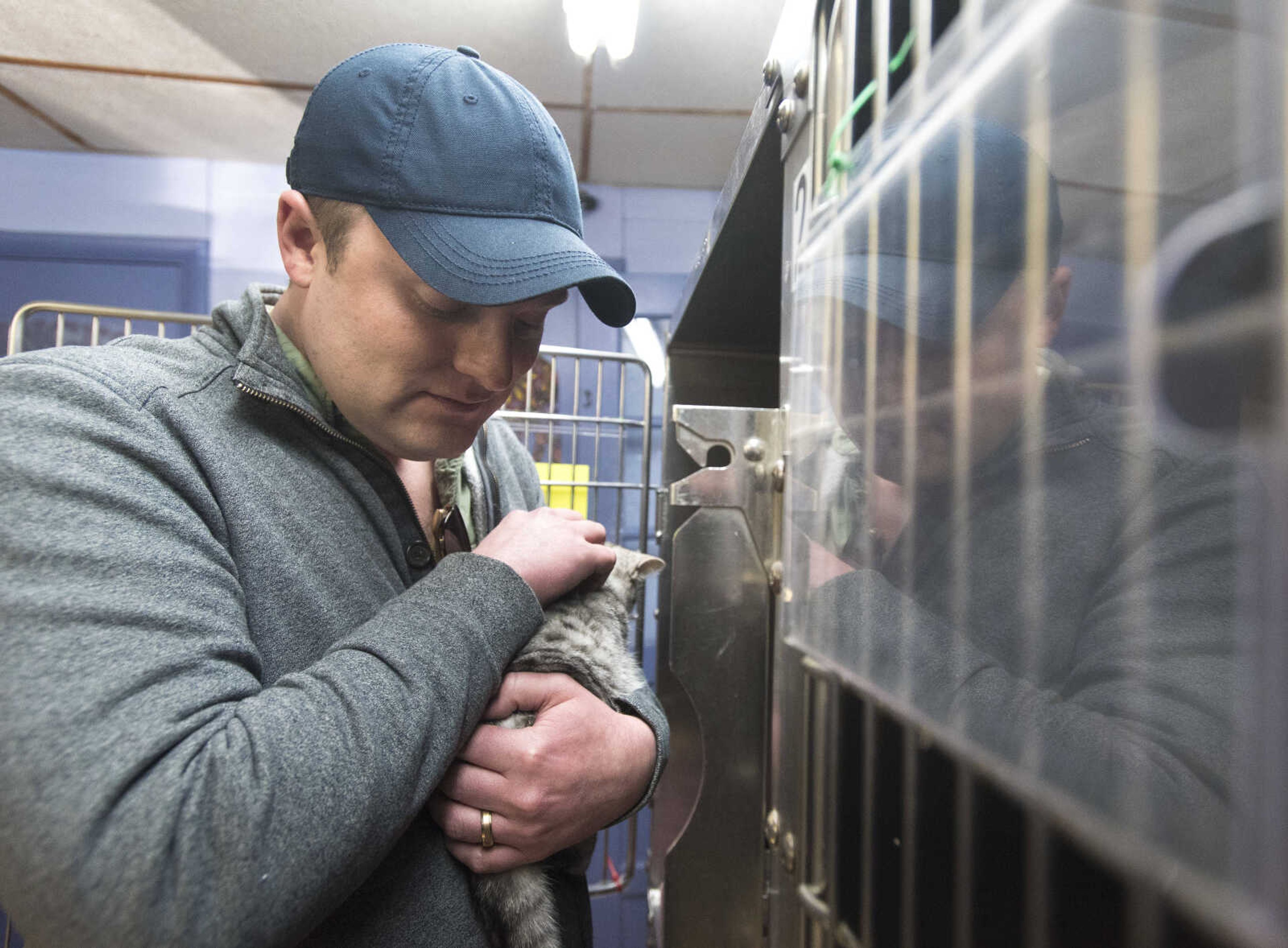 Justin Scheper pets Nova the cat at the 40th anniversary of the Humane Society of Southeast Missouri Saturday, Dec. 16 , 2017 in Cape Girardeau.