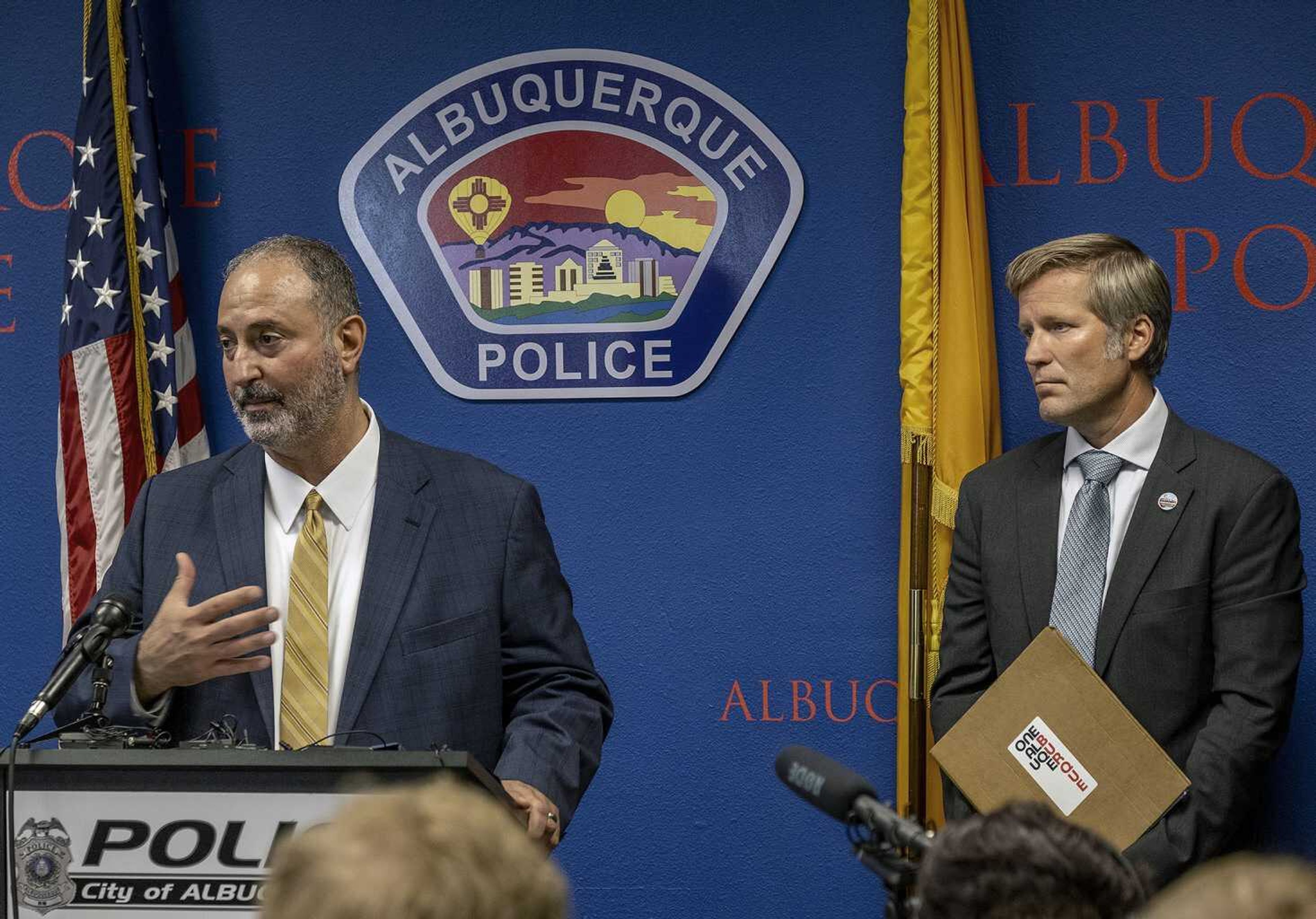 Ahmad Assed, president of the Islamic Center of New Mexico, left, speaks Tuesday at a news conference to announce the arrest of Muhammad Syed, a suspect in the recent killings of Muslim men in Albuquerque, New Mexico, as Albuquerque Mayor Tim Keller listens, at right.