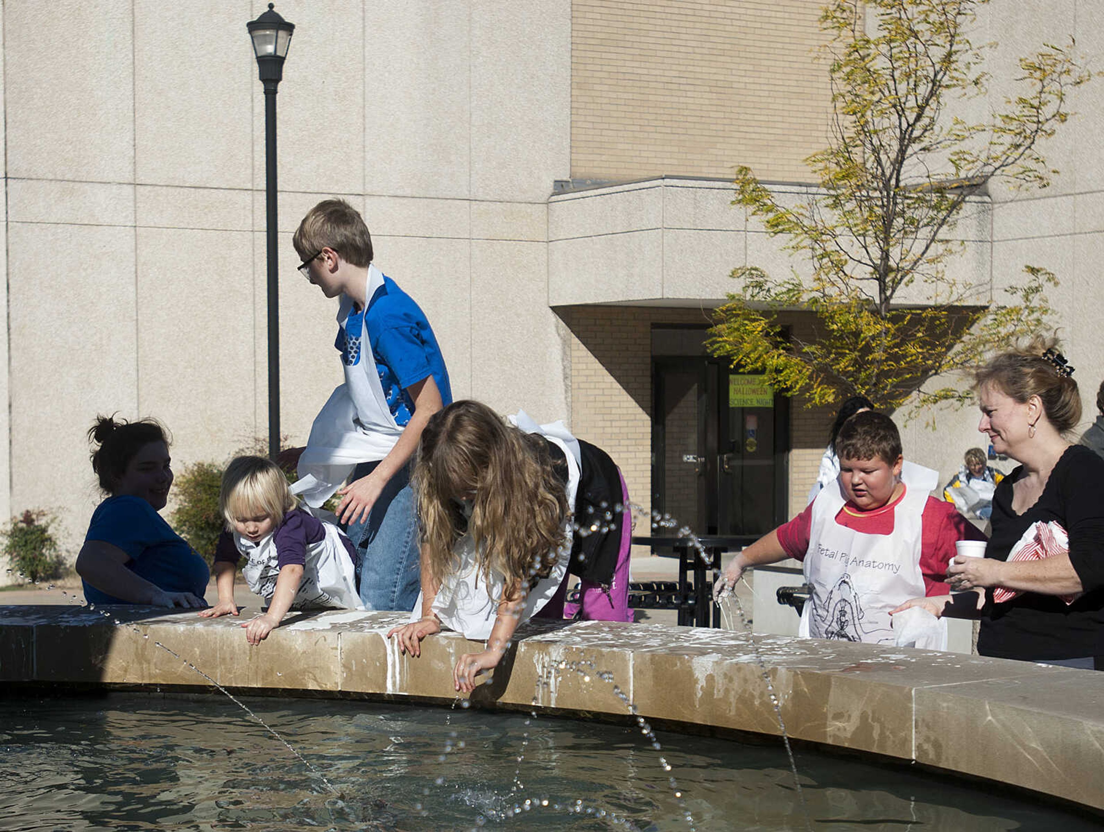 Kids clean up in the DNA Fountain during the fifth annual Halloween Science Night Sunday, Oct. 20, on the campus of Southeast Missouri State University. The event featured 21 stations, such as the "Scream Room," "Creepy Creatures," or the "Mucus Lab," each with a different Halloween themed science activity. The night is funded by a grant from the Missouri Foundation for Health in partnership with Southeast's College of Science, Technology and Agriculture and Extended and Continuing Education.