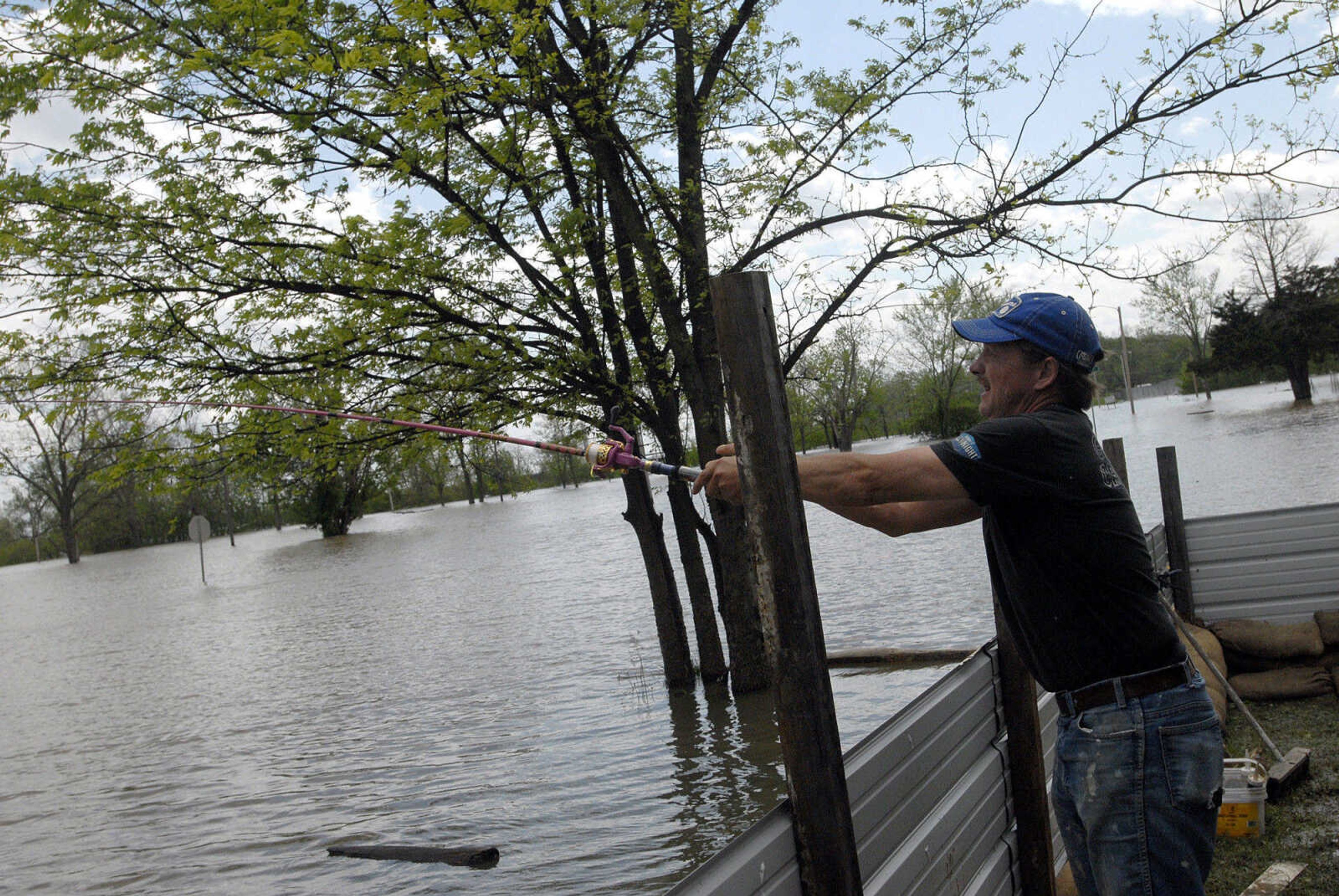 LAURA SIMON~lsimon@semissourian.com
Bill Sandquist casts his fishing line into the Mississippi River floodwater from his front yard Thursday, April 28, 2011 in Cape Girardeau.