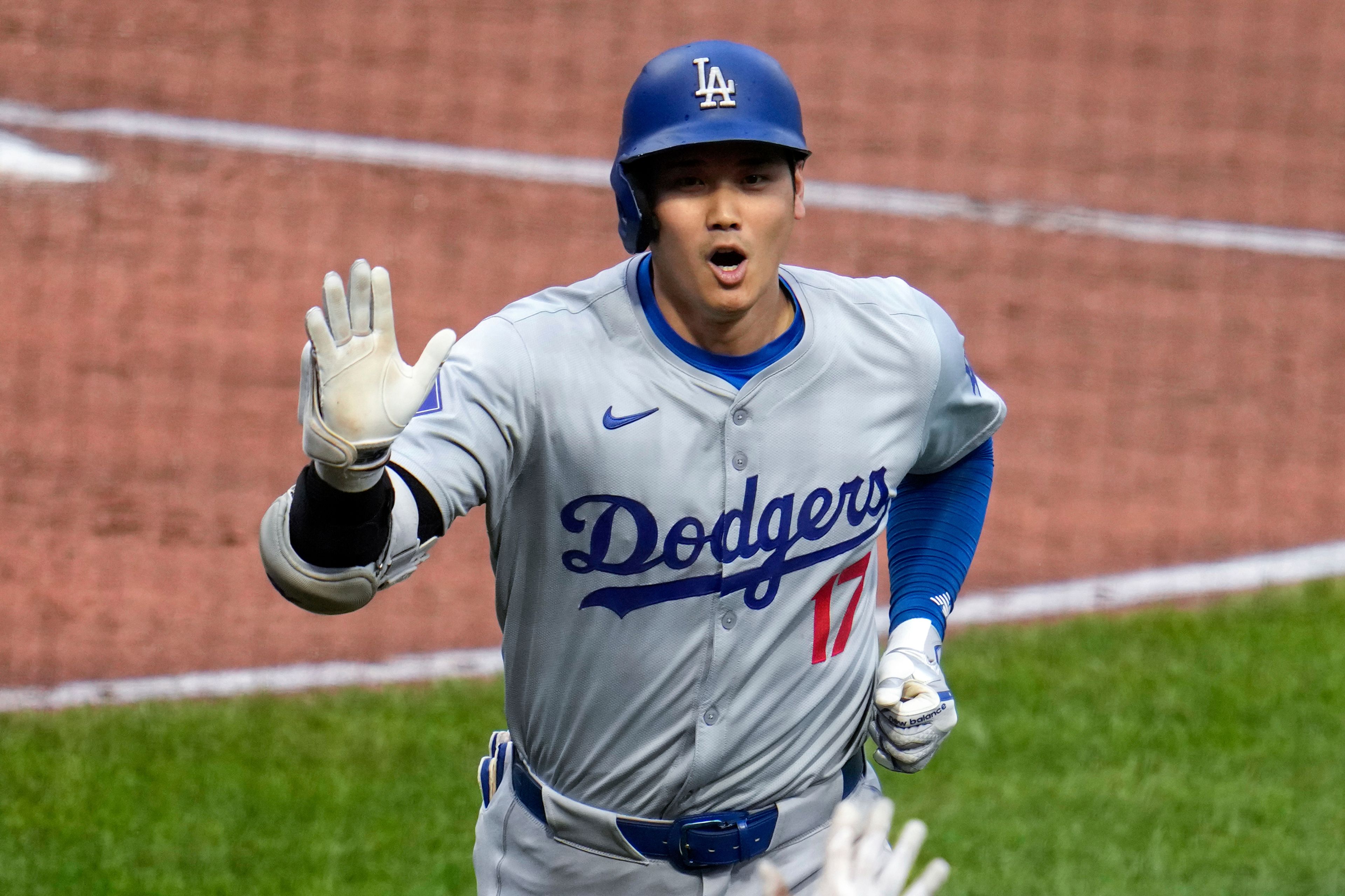 Los Angeles Dodgers' Shohei Ohtani returns to the dugout after hitting a two-run home run off Pittsburgh Pirates starting pitcher Paul Skenes during the third inning of a baseball game in Pittsburgh, Wednesday, June 5, 2024. (AP Photo/Gene J. Puskar)