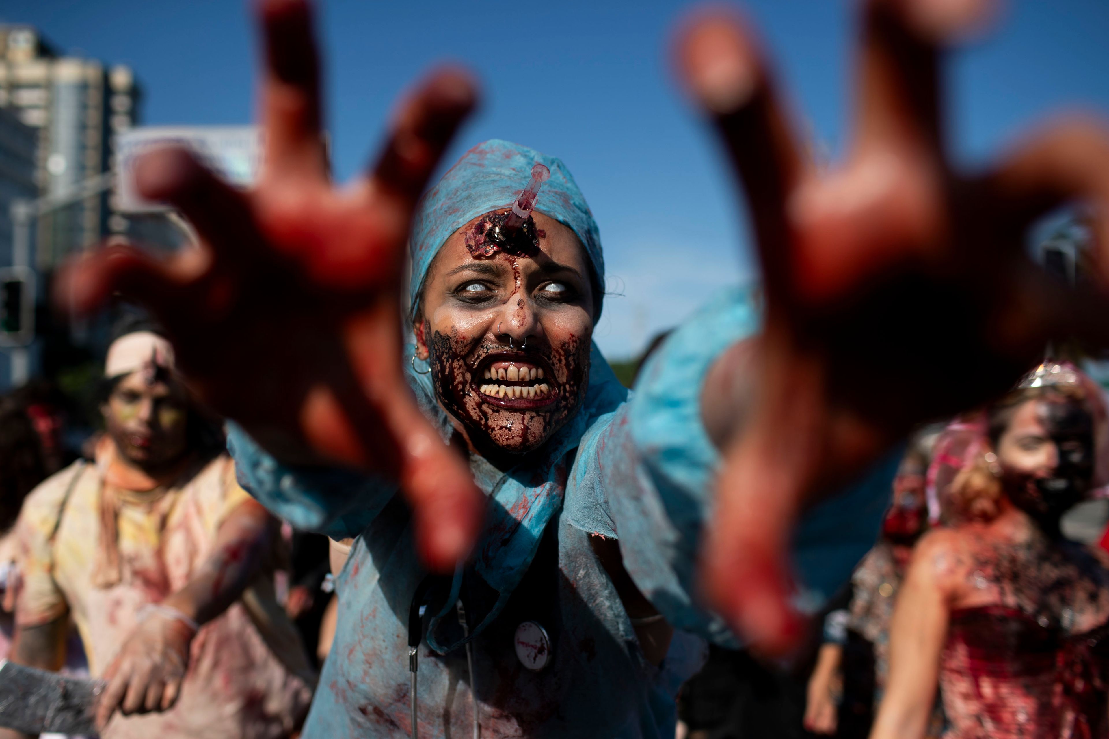 A woman dressed as a zombie surgeon strikes a pose during the Zombie Walk on Copacabana beach in Rio de Janeiro, Saturday, Nov. 2, 2024. (AP Photo/Bruna Prado)