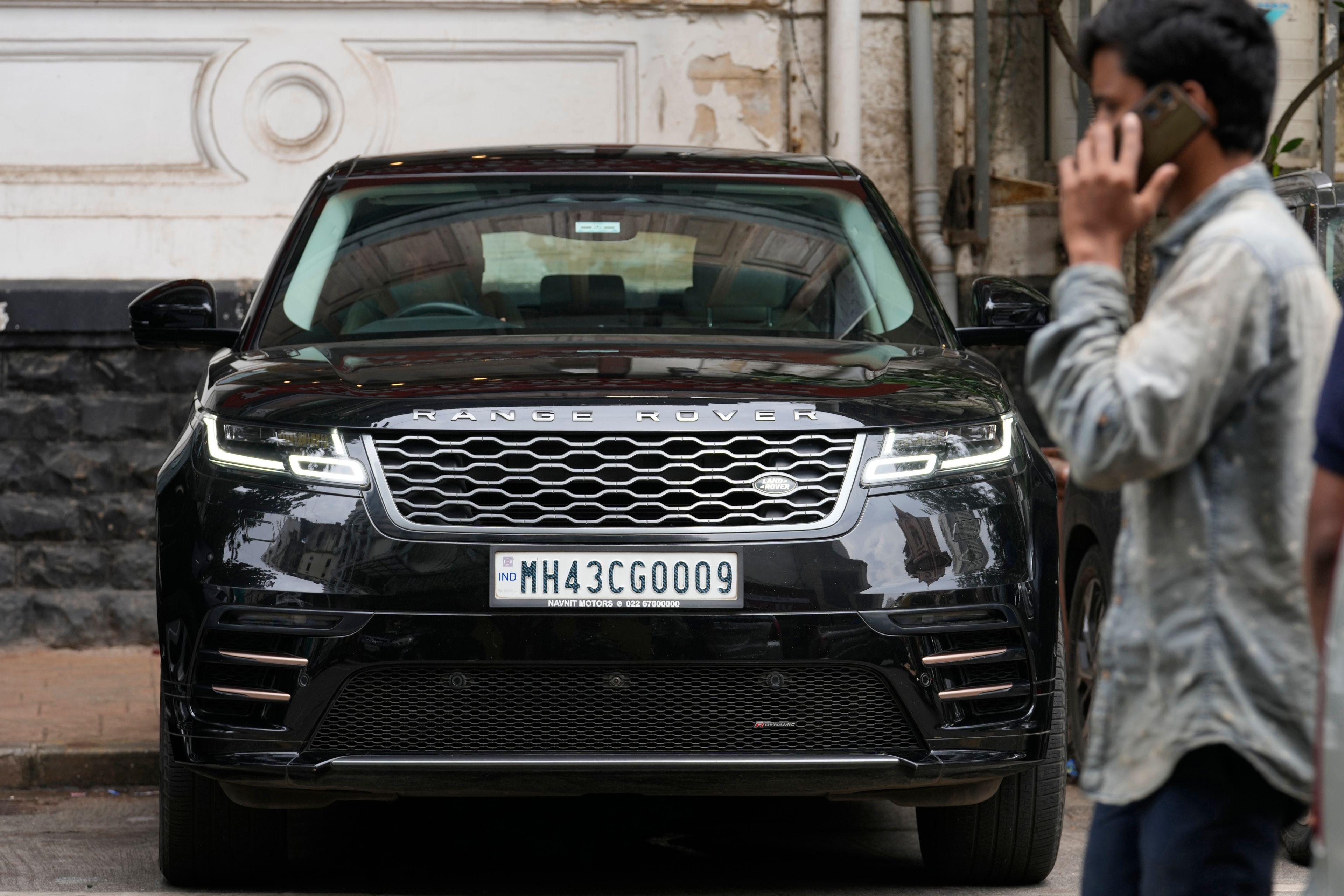 A man walks past a Tata-owned Range Rover SUV luxury car in Mumbai India, Thursday, Oct. 10, 2024. (AP Photo/Rajanish Kakade)