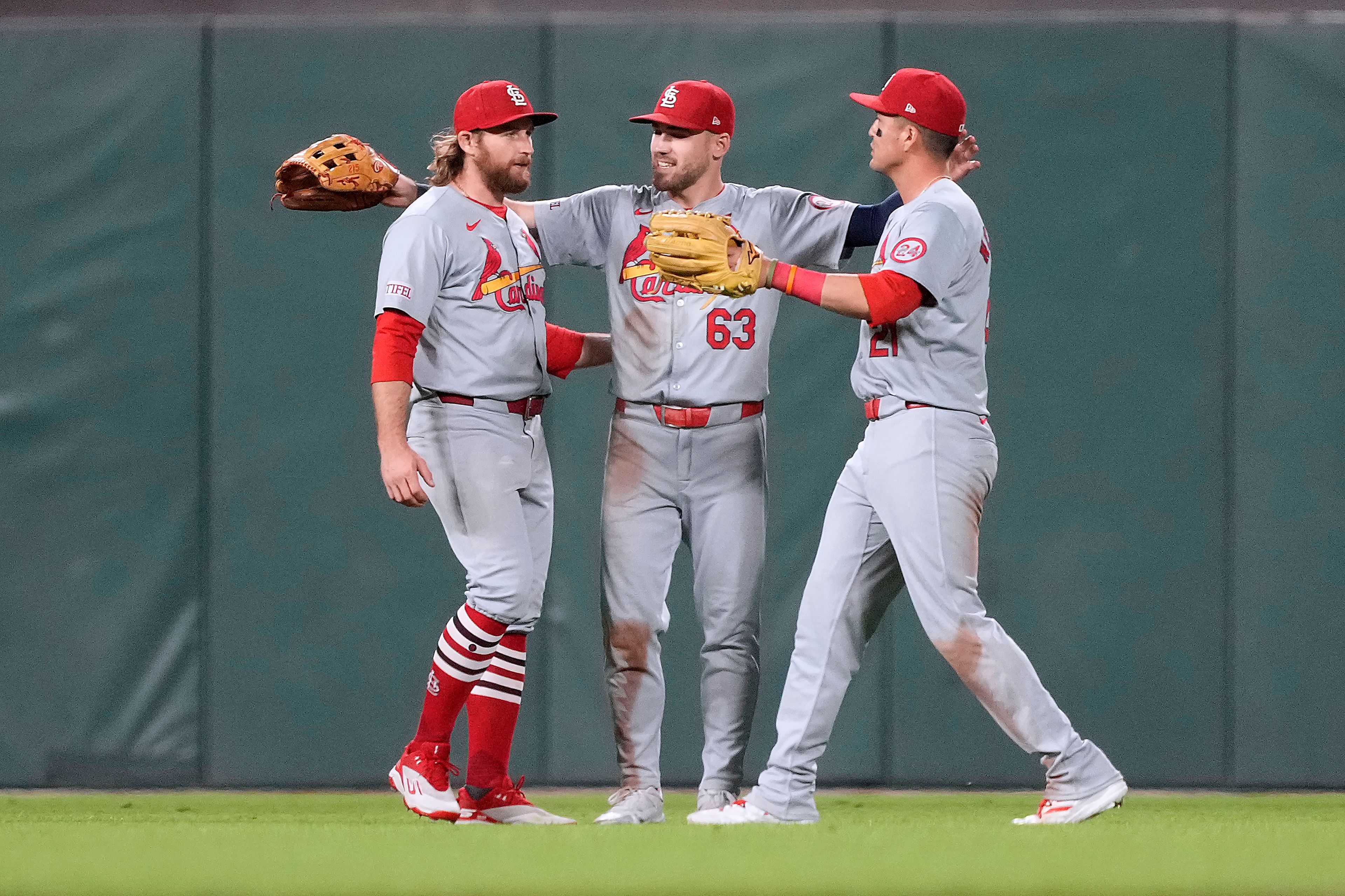 St. Louis Cardinals' Brendan Donovan, left, Michael Siani (63) and Lars Nootbaar celebrate after a victory against the San Francisco Giants in a baseball game Friday, Sept. 27, 2024, in San Francisco. (AP Photo/Tony Avelar)