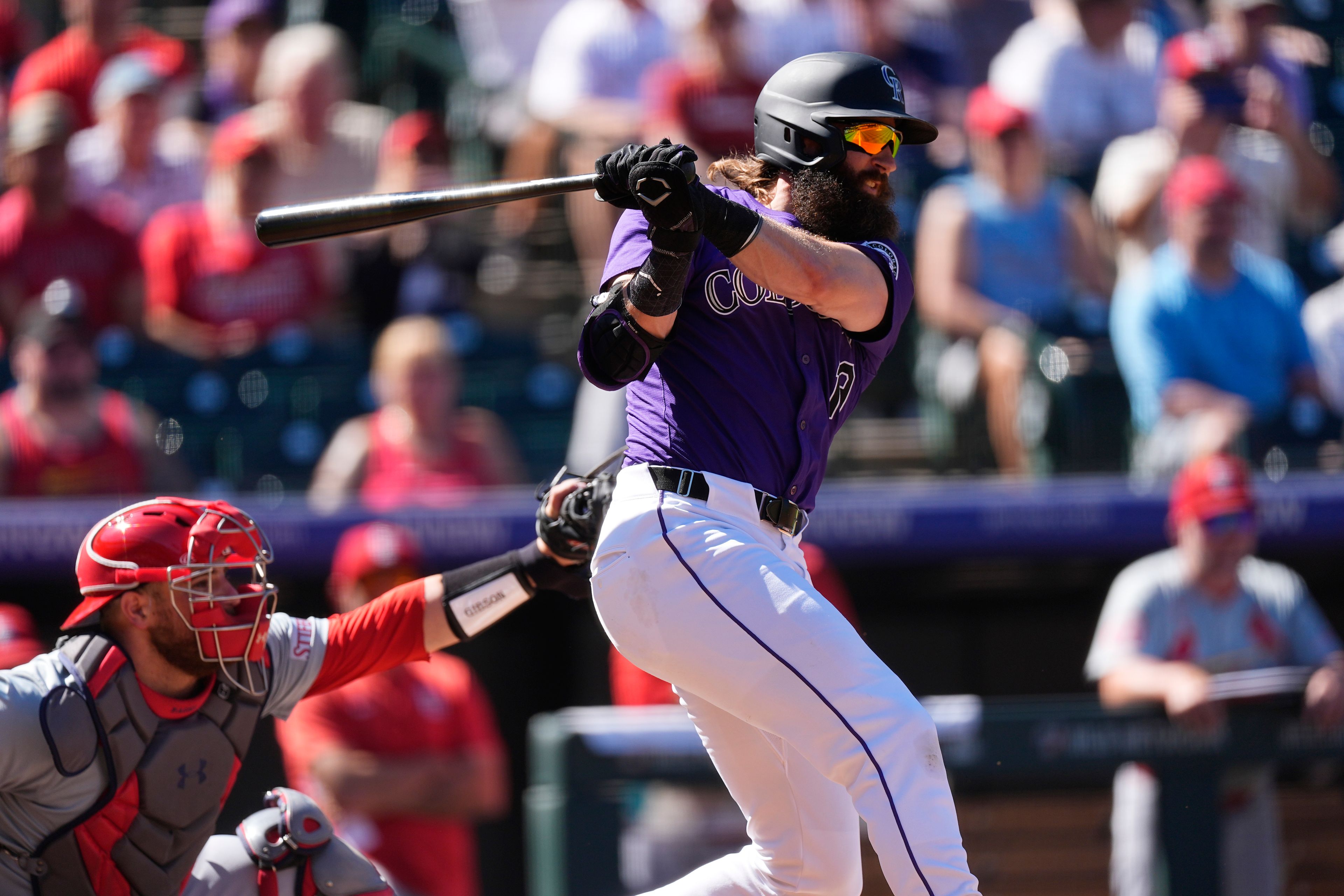 Colorado Rockies' Charlie Blackmon hits a ground ball against St. Louis Cardinals starting pitcher Kyle Gibson in first inning of a baseball game Thursday, Sept. 26, 2024, in Denver. (AP Photo/David Zalubowski)