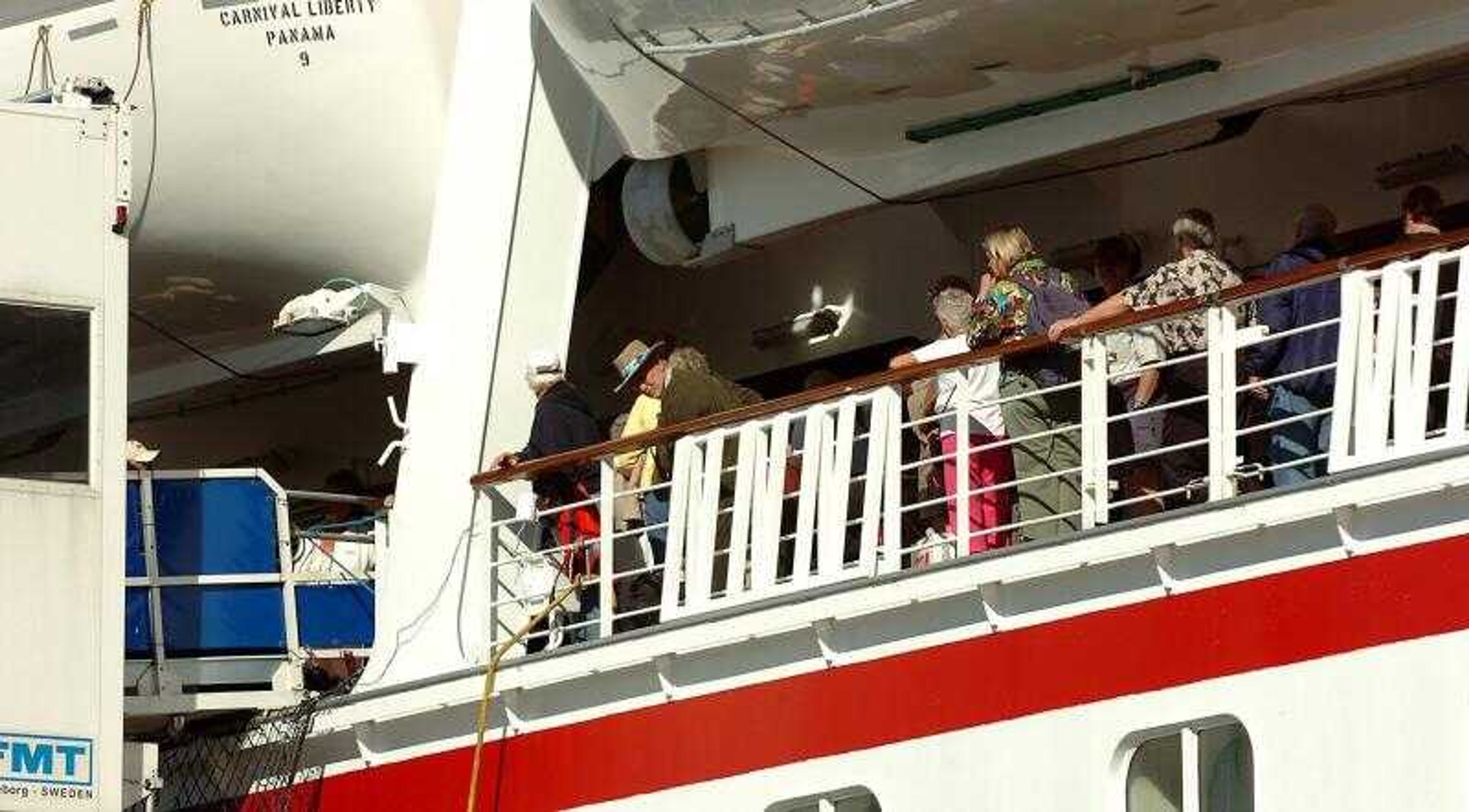 Passengers wait to exit the Carnival Cruise Lines Liberty Sunday at the Port of Everglades, in Fort Lauderdale, Fla. More than 700 passengers aboard the trans-Atlantic cruise fell ill with flu-like symptoms, cruise line officials said. (STEVE MITCHELL ~ Associated Press)