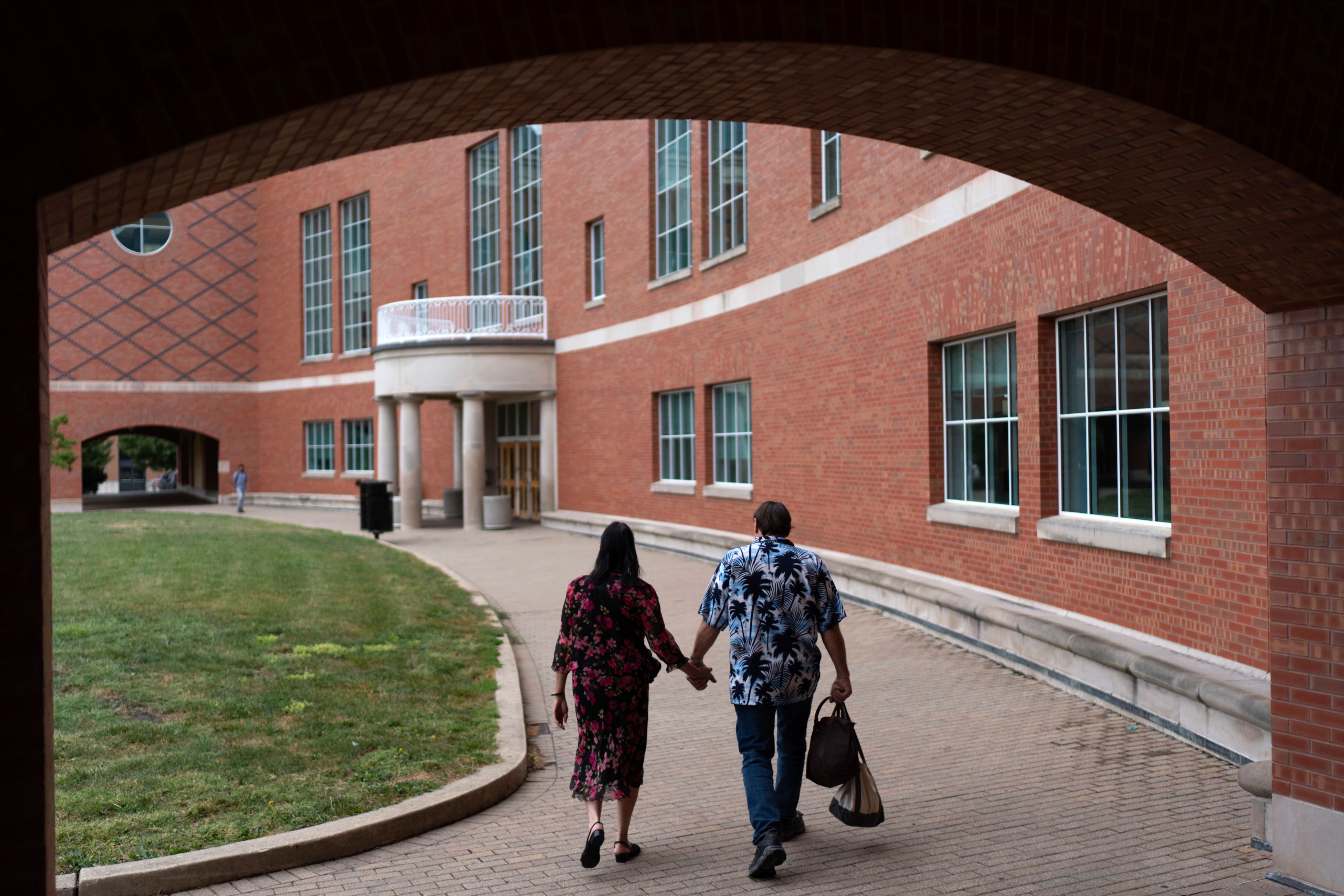 Matt Dzik, right, drops his wife, Lesley, off at work at the engineering library at the University of Illinois in Urbana, Ill., Sunday, Sept. 22, 2024. (AP Photo/David Goldman)