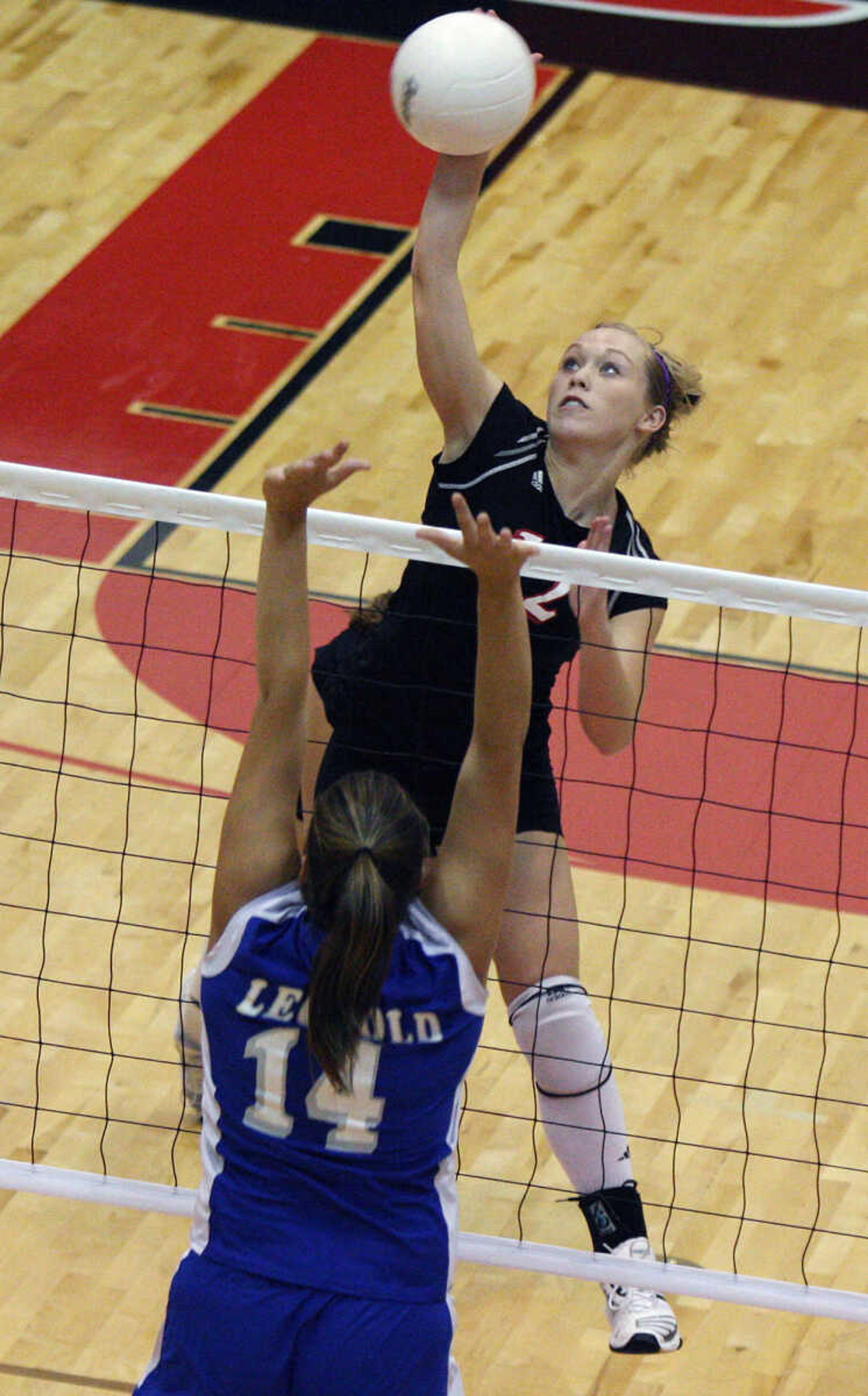 Taylor Glueck spikes the ball during the Jackson-Leopold game Thursday night.