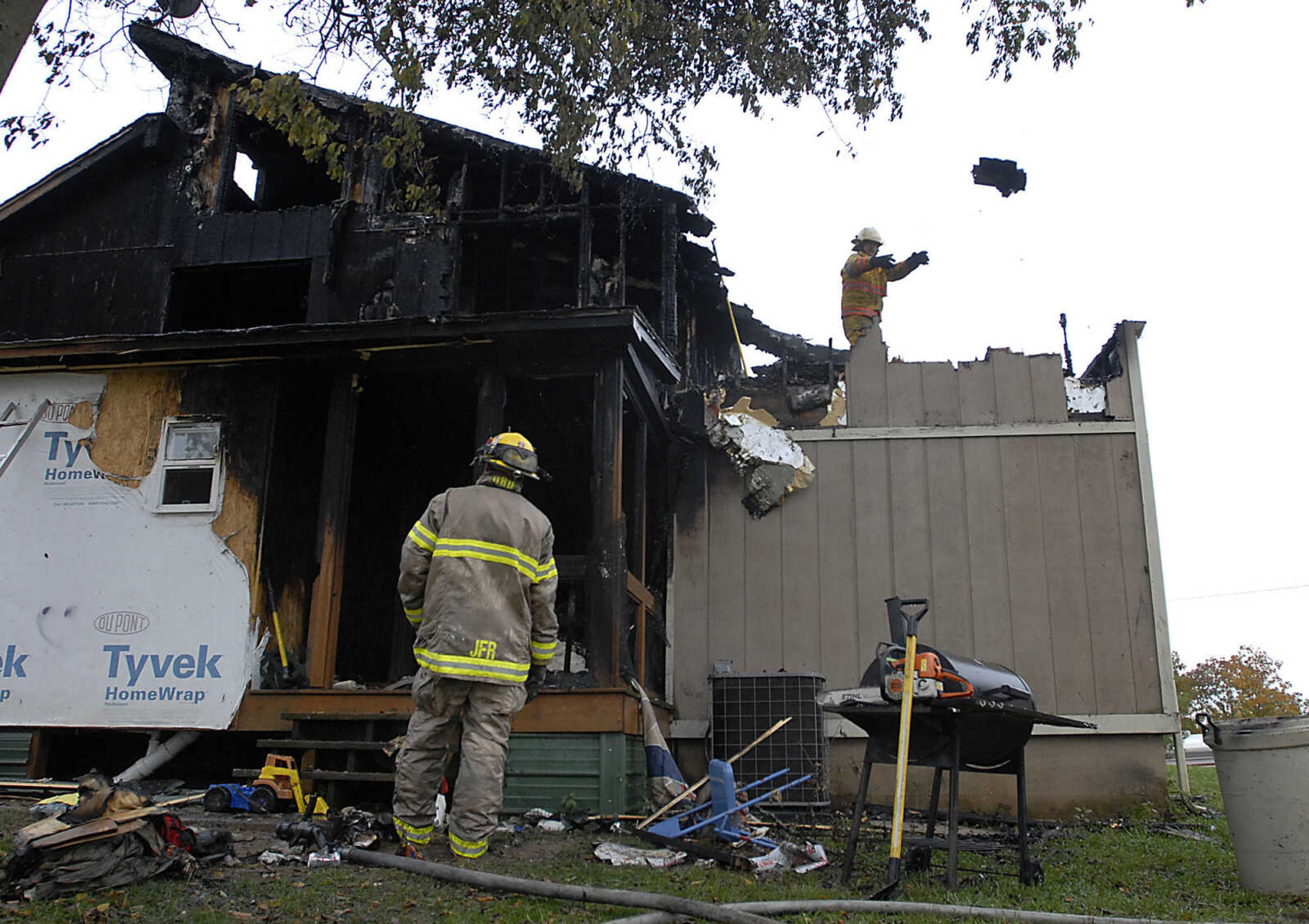 KIT DOYLE ~ kdoyle@semissourian.com
Area firefighters clear areas of the Ladd home following a blaze Friday, October 16, 2009, north of Jackson on Big Cone Lane.