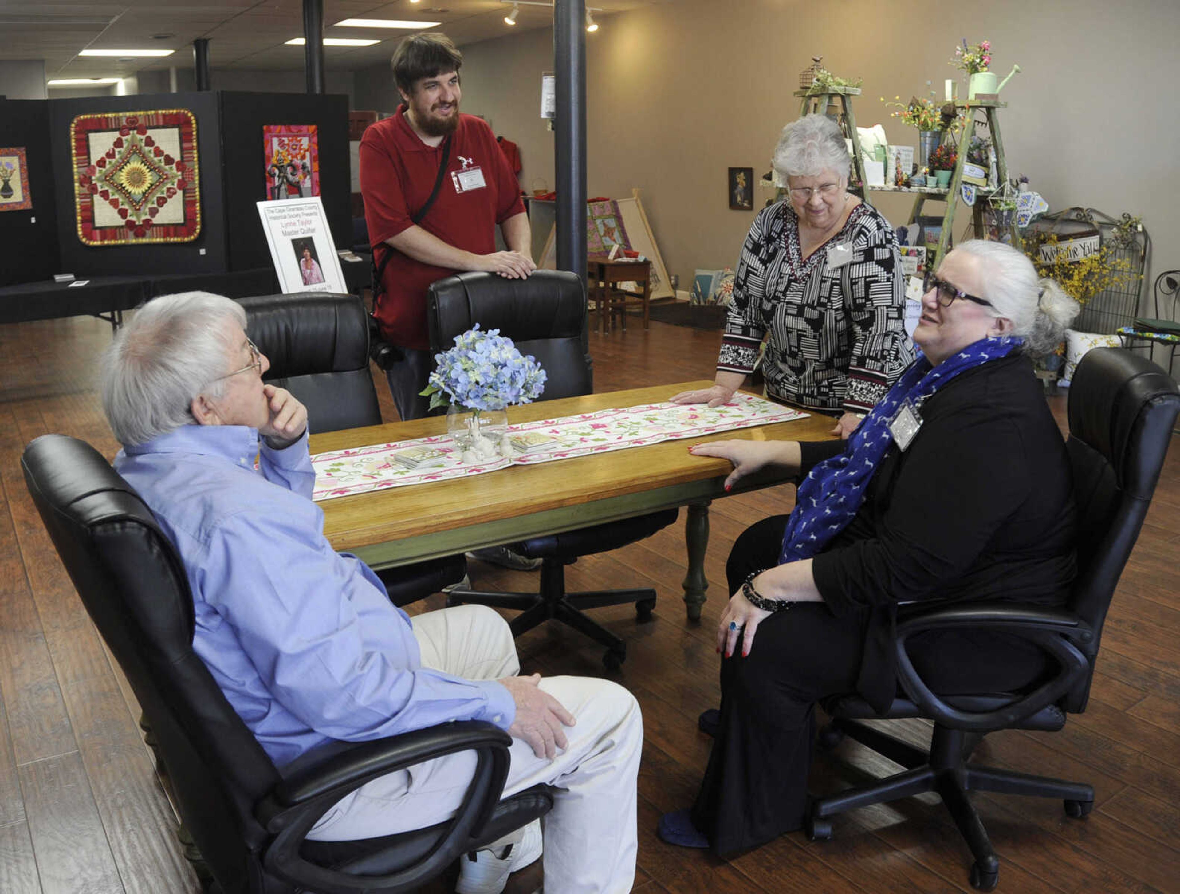 Lynn Degenhardt, left, visits with James Baughn, Jane Boren and Carla Jordan Sunday, March 15, 2015 at the Cape Girardeau County History Center in Jackson.