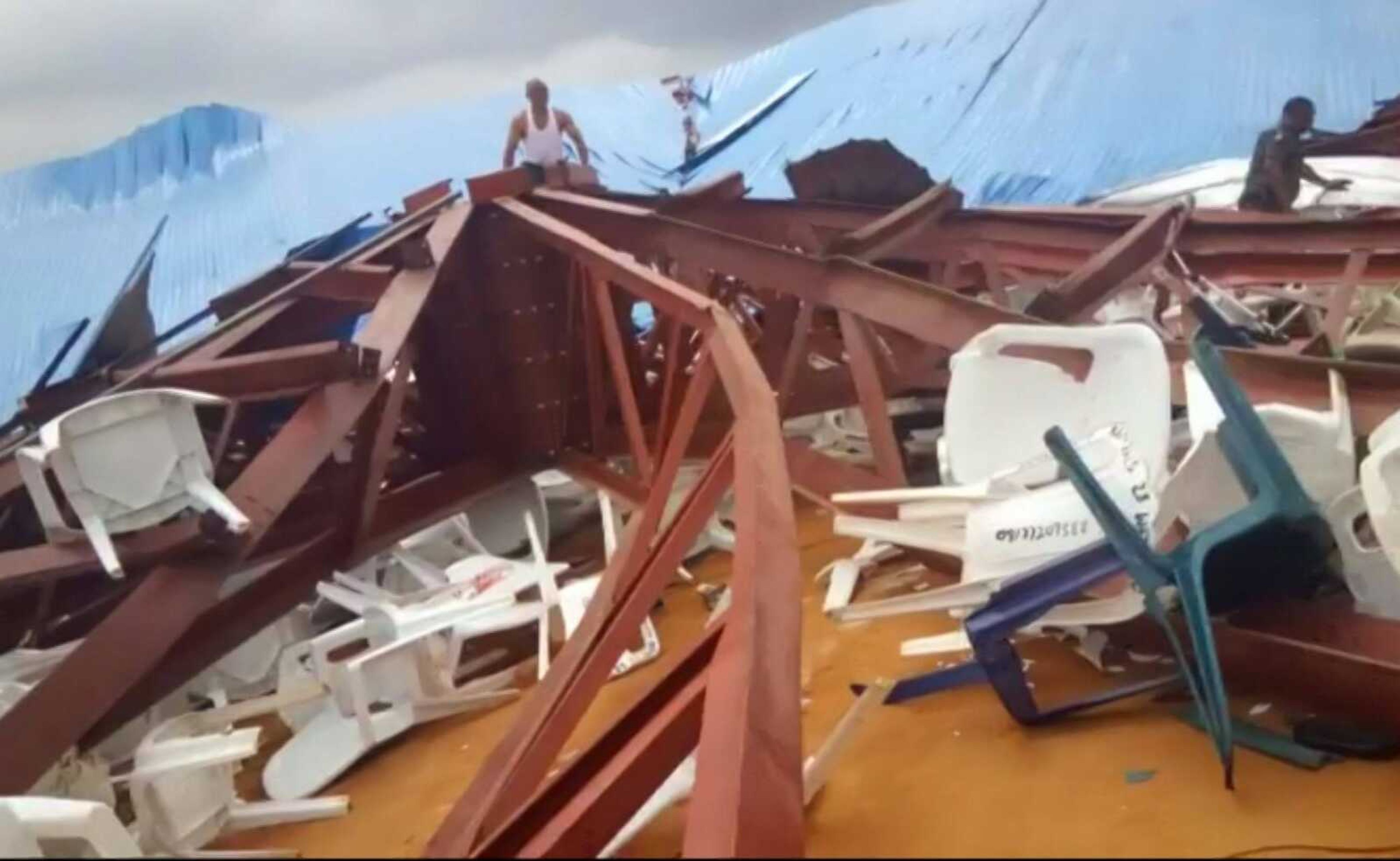 Local people survey the scene after a church roof collapsed Saturday in Uyo, Nigeria.