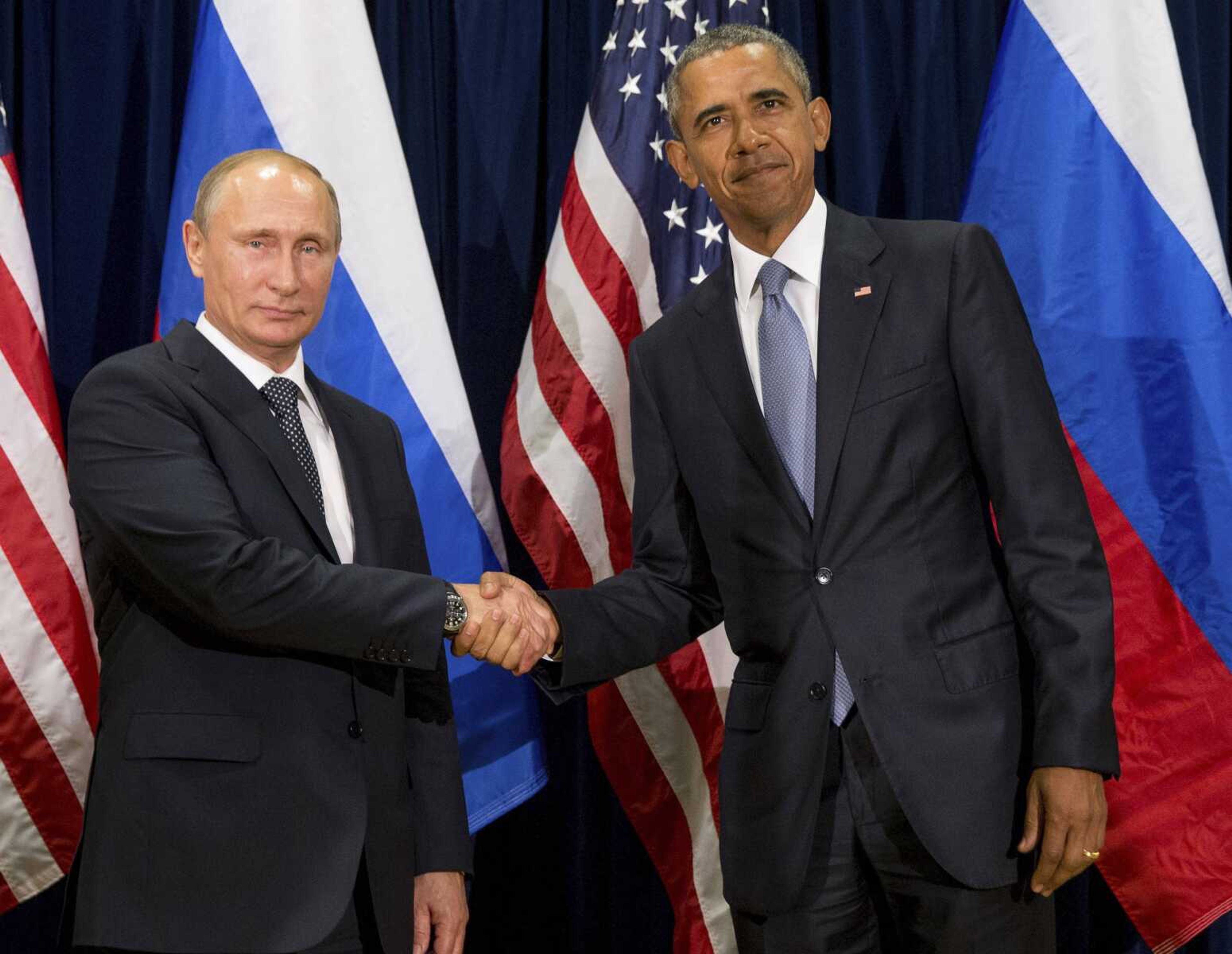 President Barack Obama and Russia's President President Vladimir Putin pose for members of the media before a bilateral meeting in September 2015 at the United Nations headquarters. Obama is promising the U.S. will retaliate against Russia for its suspected meddling in America's election process, an accusation the Kremlin has denied.