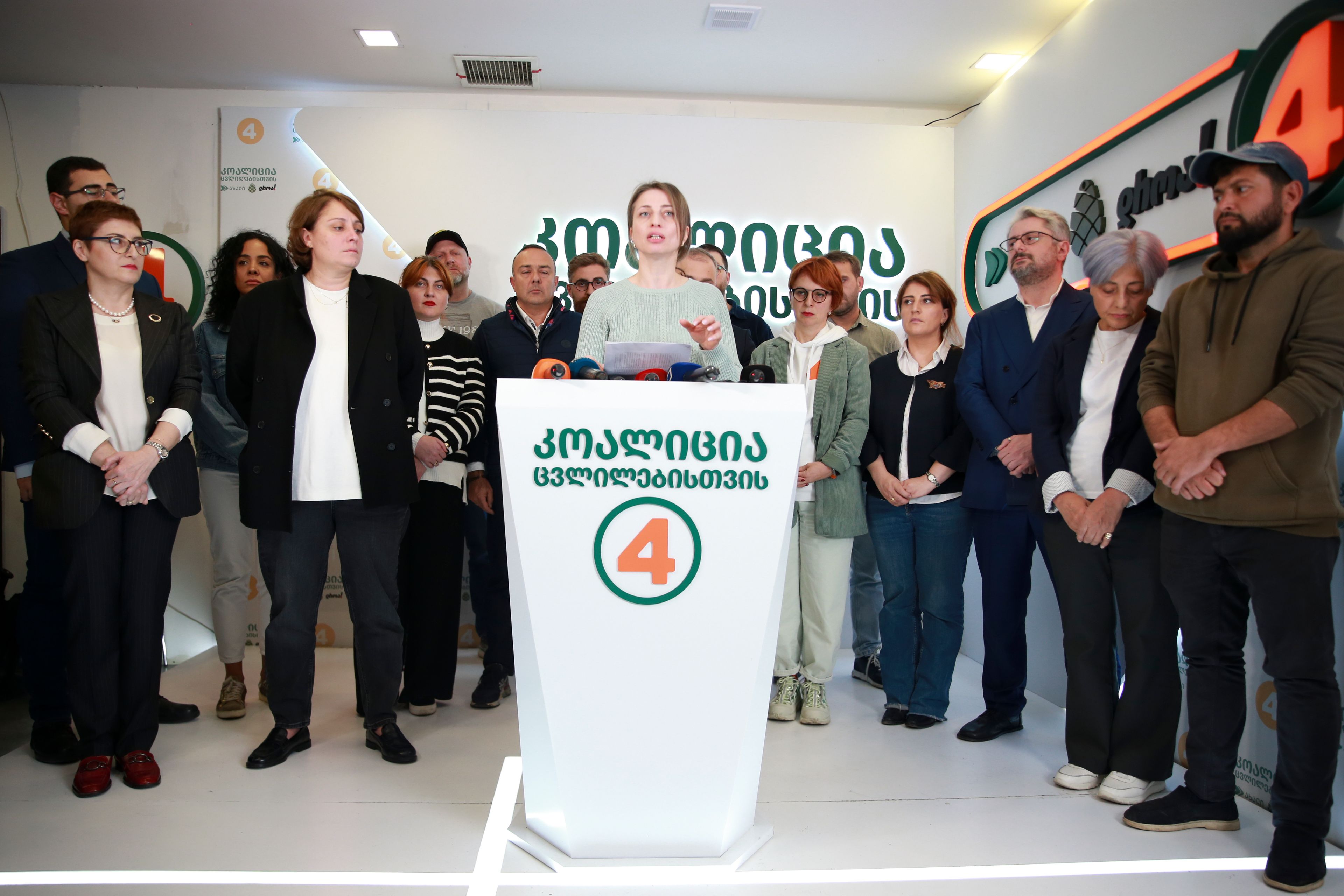 Nana Malashkhia, who leads the Coalition for Change parliament list, center, speaks to the media at coalition's headquarters after the parliamentary election in Tbilisi, Georgia, Sunday, Oct. 27, 2024. (AP Photo/Zurab Tsertsvadze)