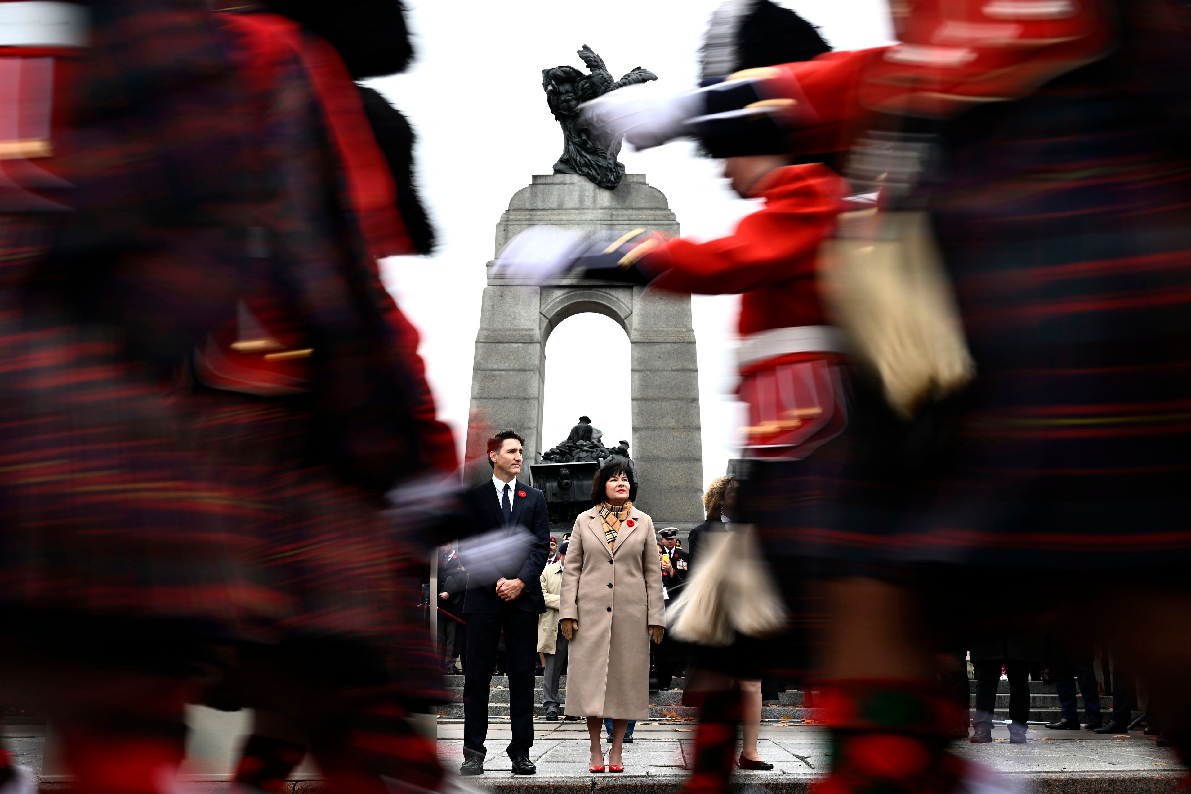 Canadian Prime Minister Justin Trudeau, center left, and Minister of Veterans Affairs and Associate Minister of National Defence Ginette Petitpas Taylor watch as Canadian Forces members march off to conclude the Remembrance Day ceremony at the National War Memorial in Ottawa, Ontario, Monday, Nov. 11, 2024. (Justin Tang/The Canadian Press via AP)