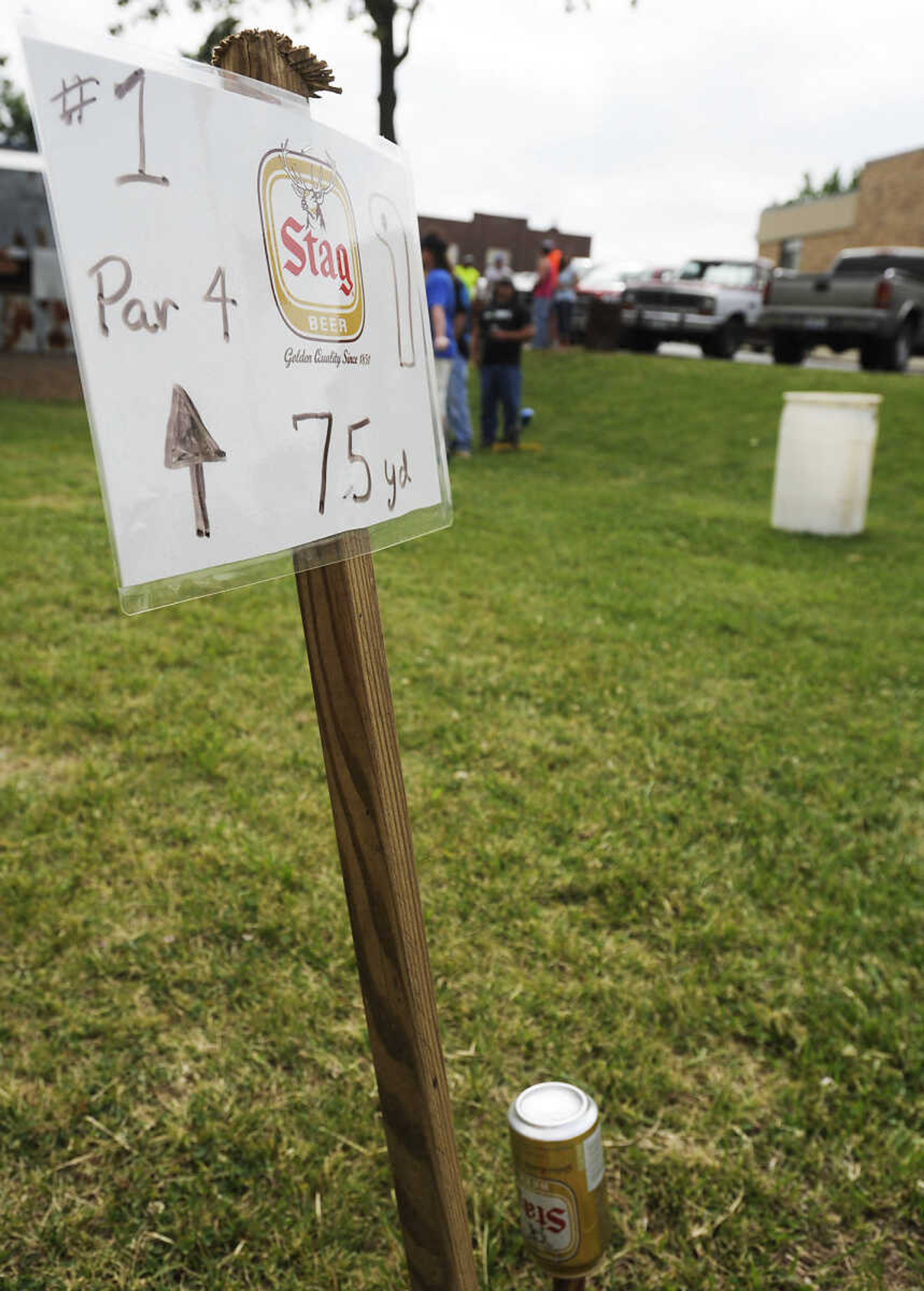 The first hole tee box is marked with a sign and two Stag beer cans during the Kow Pasture Klassic at Schindler's Tavern in New Hamburg Saturday, April 28. Teams play a nine-hole course laid out in a pasture behind the tavern using tennis balls and a variety of objects as clubs, including tennis rackets, oars and mallets.