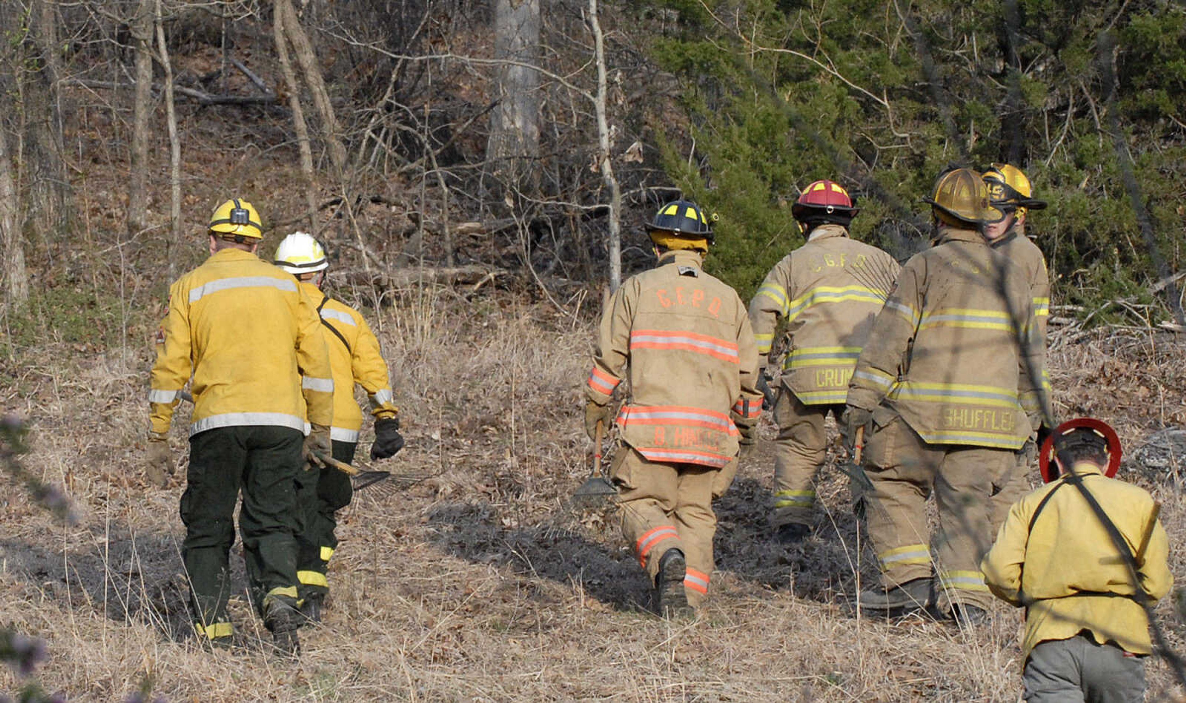 LAURA SIMON~lsimon@semissourian.com
Firefighters head into the woods to battle a natural cover fire off of Cissus Lane near Neelys Landing Sunday, April 3, 2011. Firefighters from Cape Girardeau, Perry, Scott, and Bollinger Counties contained the blaze that ravaged 50 acres of land.