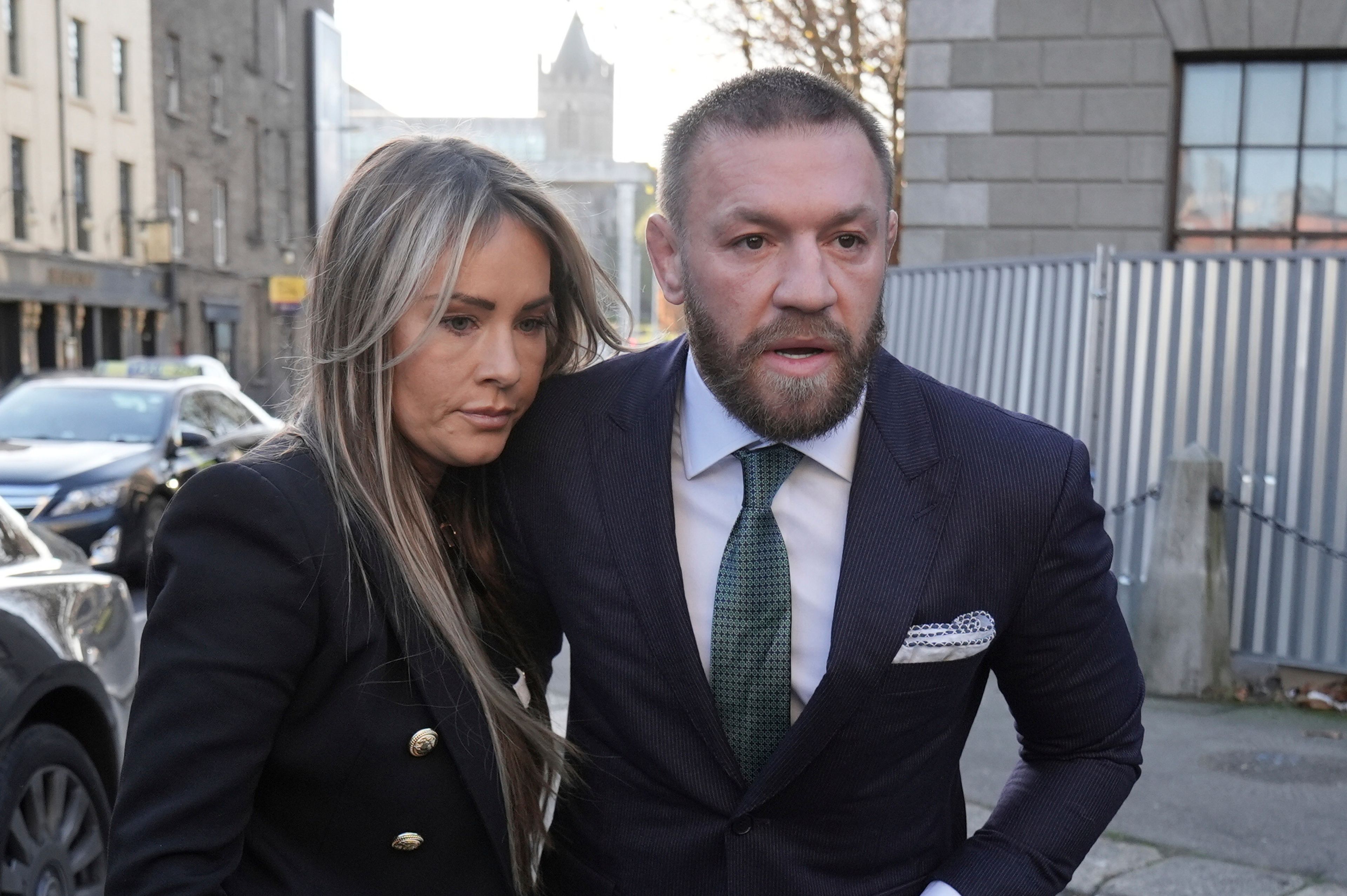 Mixed martial arts fighter Conor McGregor and partner Dee Devlin walk outside the High Court in Dublin, Ireland, where he is appearing for a personal injury case against him, on Friday Nov. 22, 2024. (Brian Lawless/PA via AP)