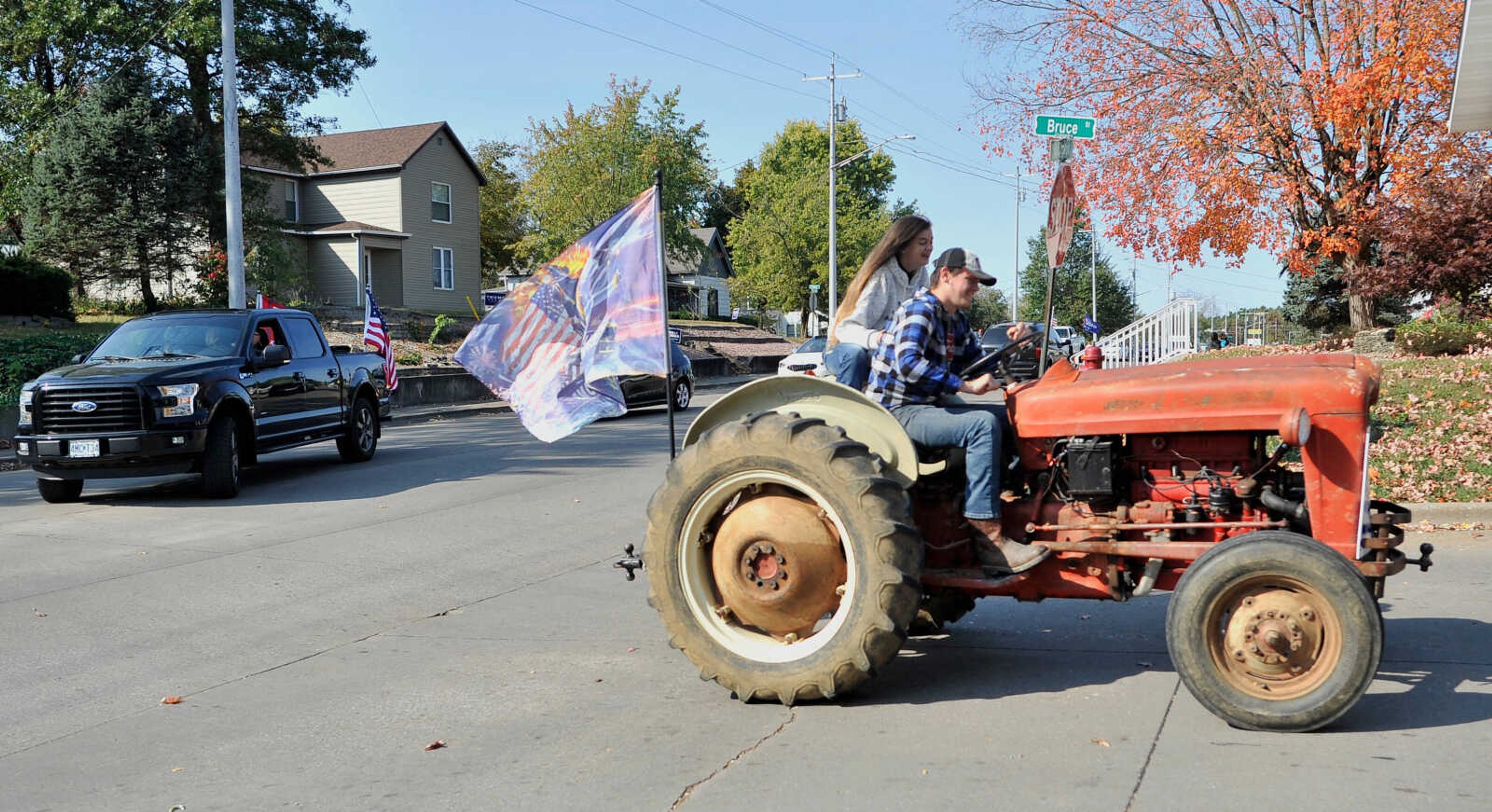 Brooke Holford ~ Southeast Missourian
A tractor with two passengers rides in the America Truck Parade on Saturday, Oct. 17, 2020, in Perryville, Missouri.