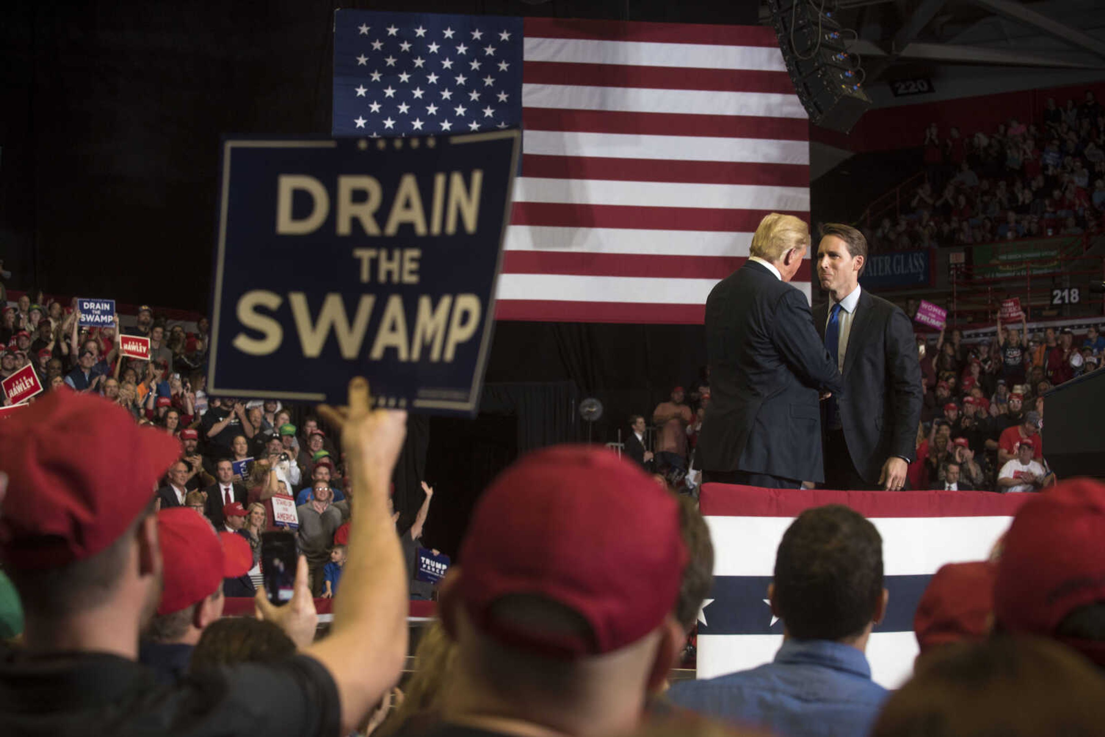 Missouri Attorney General and U.S. Senate candidate Josh Hawley, far right, shakes hands with President Donald Trump after speaking at a Make America Great Again rally Monday, Nov. 5, 2018, at the Show Me Center in Cape Girardeau.