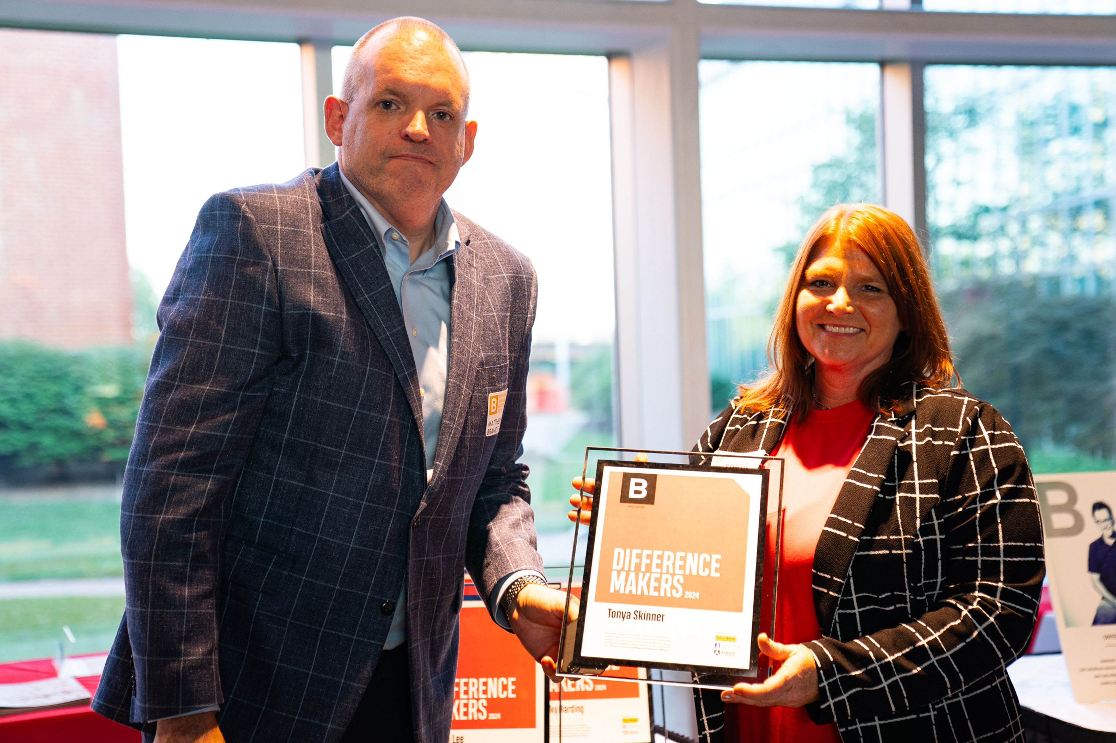 Tonya Skinner receives a plaque from Saint Francis Healthcare System’s Matthew Brandt recognizing her as a 2024 Difference Maker at their reception at Southeast Missouri State University’s River Campus. The Difference Maker’s reception was presented by B Magazine on Thursday, Sept. 6.