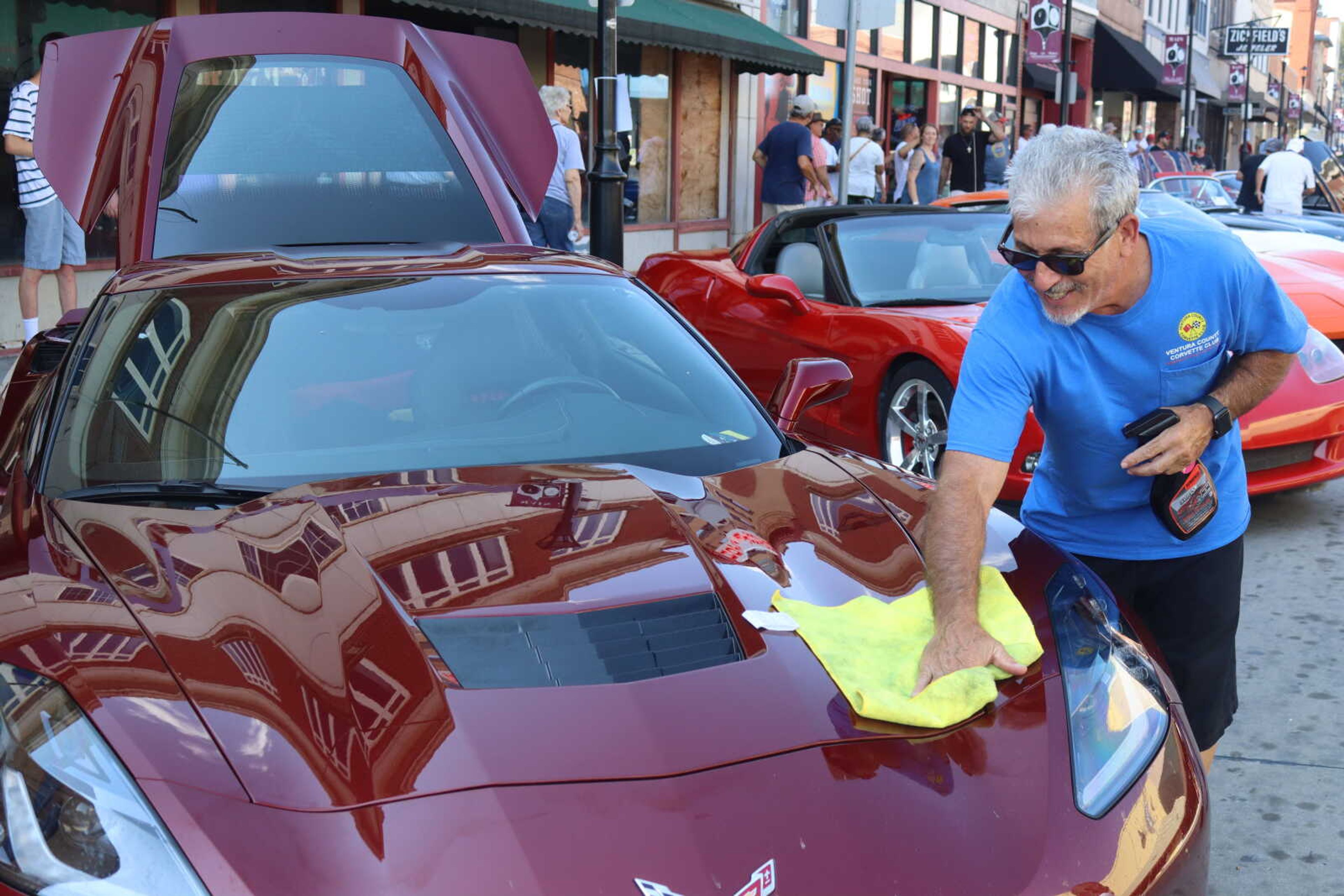 Bruce Waisman from California cleans his Corvette after a long drive to Cape Girardeau. 