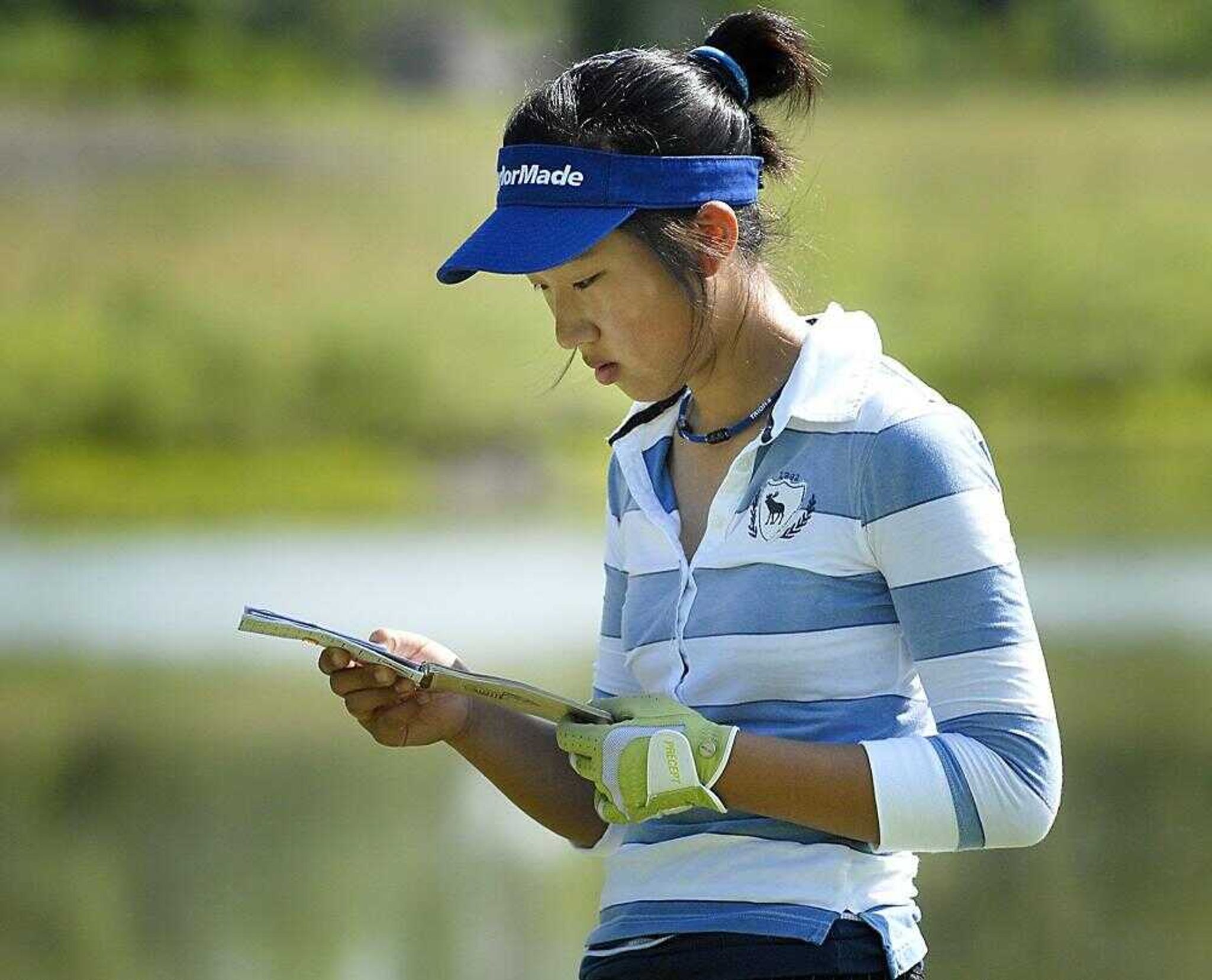 Hanule Seo of St. Louis checked her yardage book on the 10th hole of the AJGA Dalhousie Junior Championship on Thursday. (Kit Doyle)