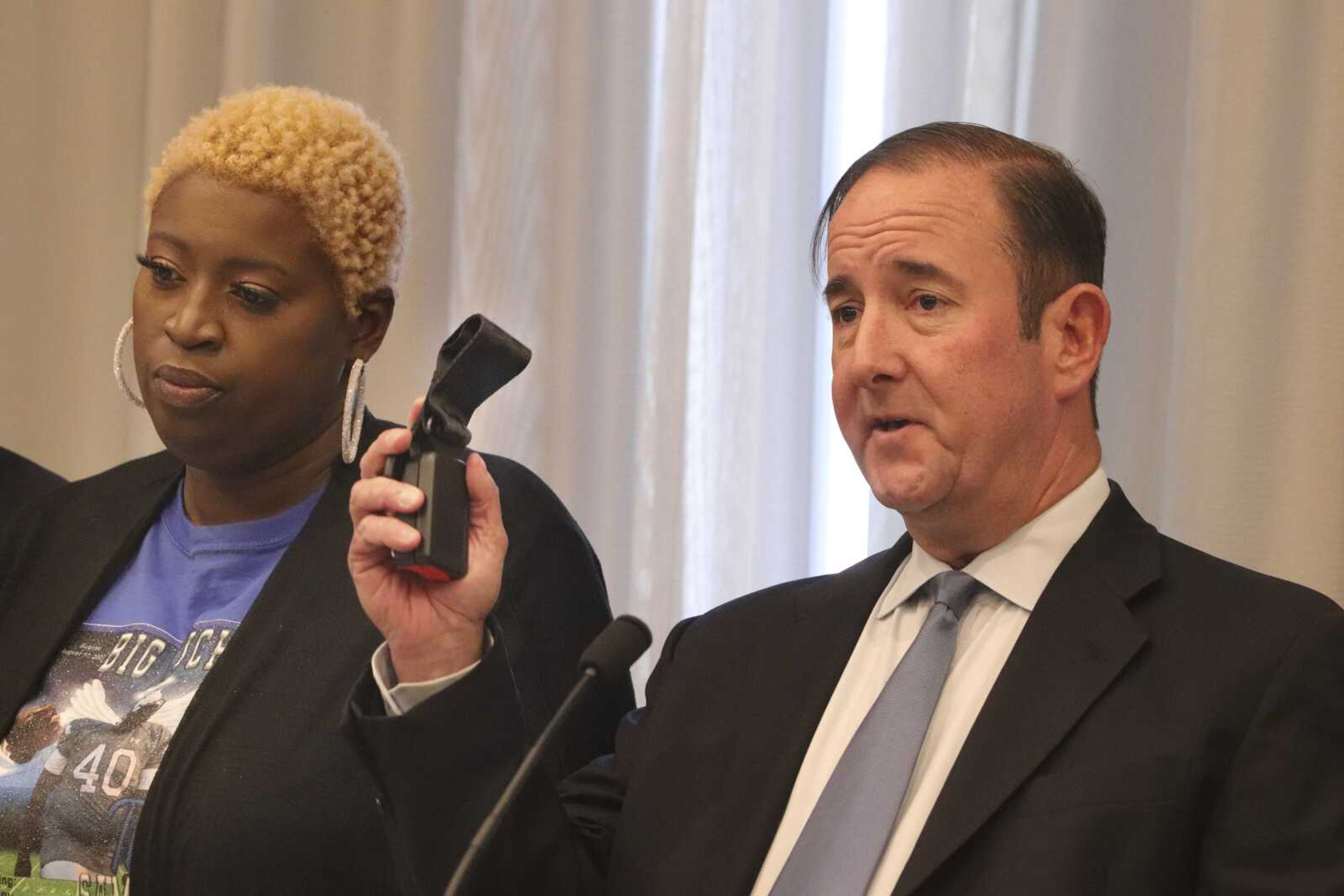 Michael Haggard, lawyer for Nekia Dodd, left, the mother of Tyre Sampson, speaks at a Tuesday news conference in St. Louis. Dodd said her son's death has left her struggling with emotions ranging from frustration to grief to anger.