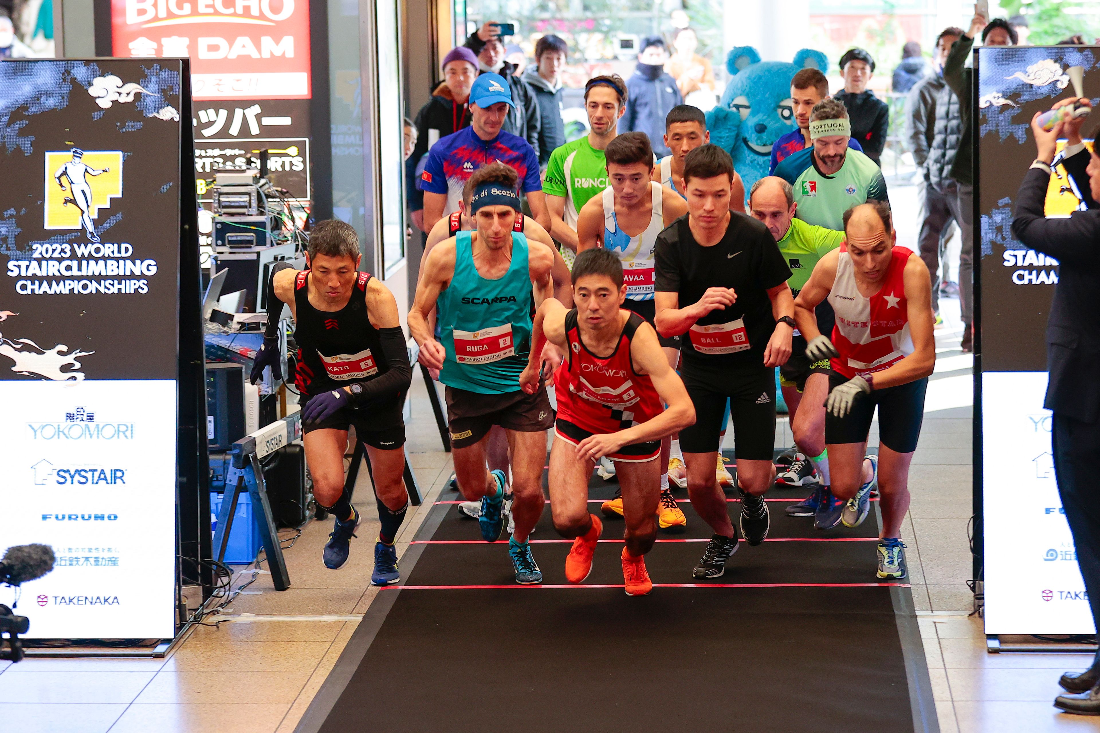 In this photo provided by ISF/Meeting, competitors start a race of Stairclimbing World Championships in Osaka, western Japan, Nov. 19, 2023. (ISF/MEETING via AP)