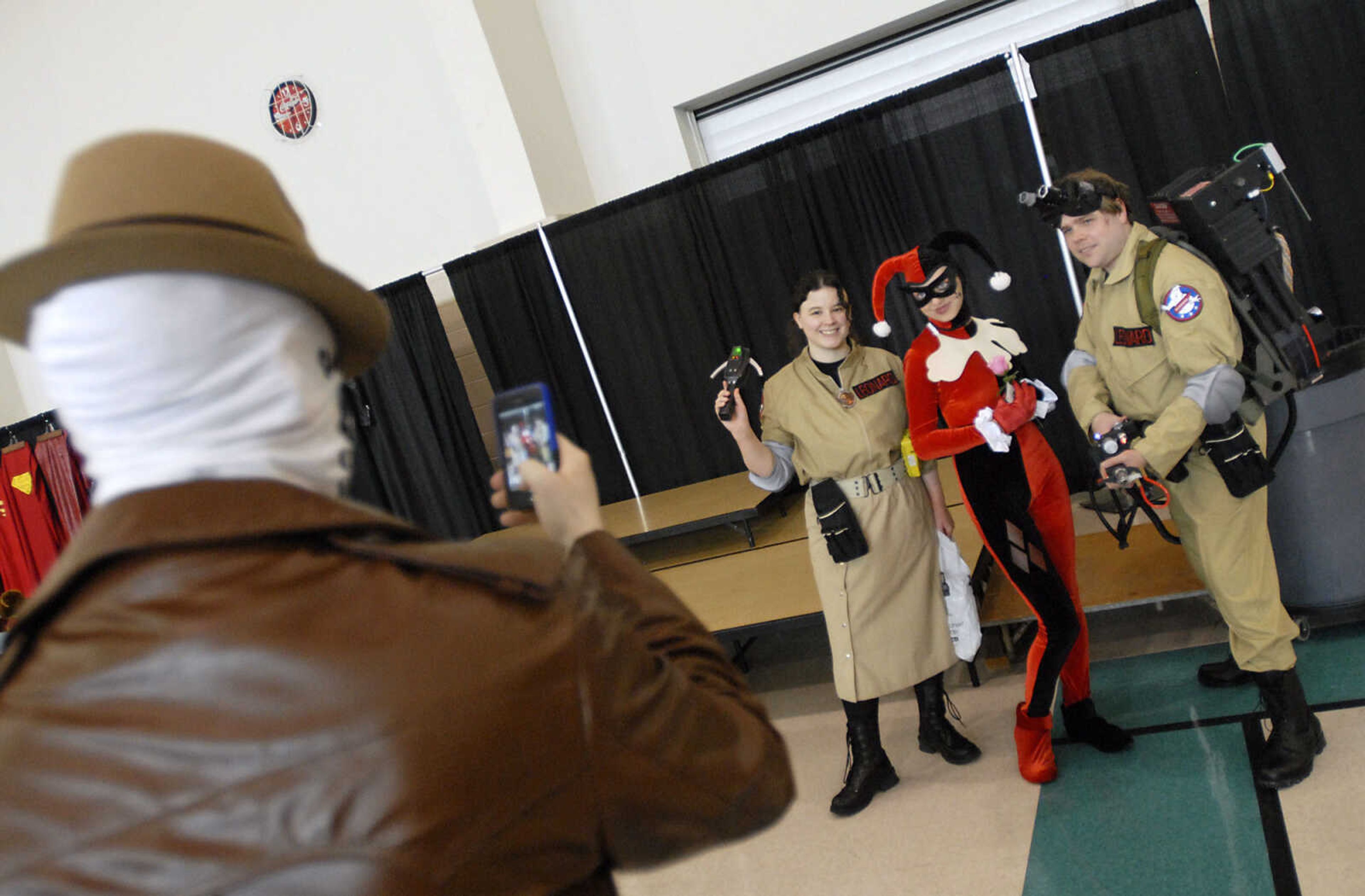 KRISTIN EBERTS ~ keberts@semissourian.com

Kevin Carter, left, dressed as Rorschach, snaps a photo of Amanda Bruns, center, dressed as Harley Quinn posing with Ghostbusters Melissa and Steven Leonard during the sixth annual Cape Comic Con on Saturday, June 25, 2011, at the Osage Centre in Cape Girardeau.