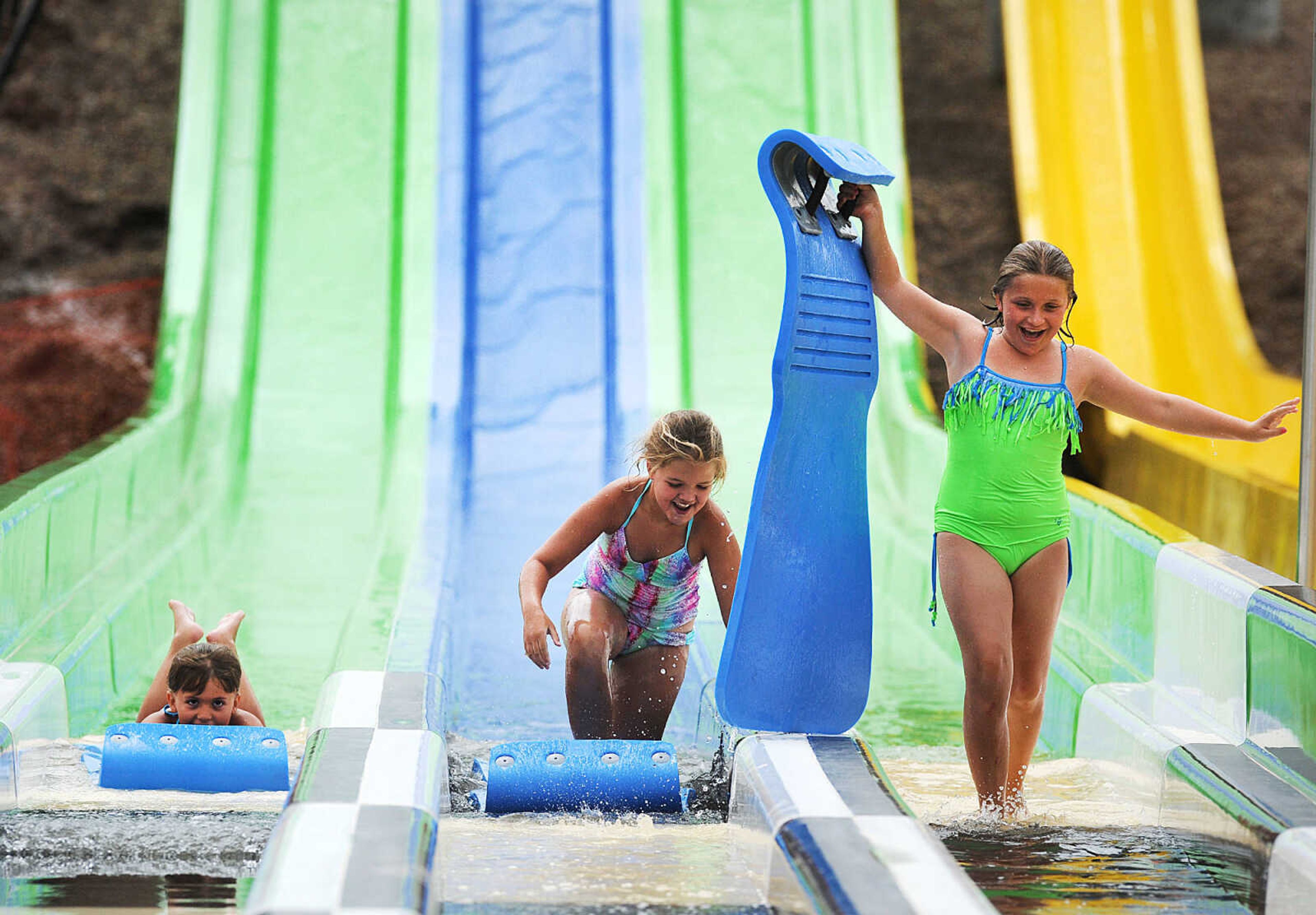 LAURA SIMON ~ lsimon@semissourian.com

Lyla Craft, left, Ava Watkins, center, and Nora Craft land at the bottom of the new three-Lane 319-foot-long mat racer at Cape Splash, Thursday, July 9, 2015. The trio were the first patrons to ride on the new waterslide.The Cape Girardeau Parks and Rec Department opened the new additions of a 265-foot-long free-fall slide, 259-foot-long triple-drop slide and a three-Lane 319-foot-long mat racer with 30-foot tower, to the aquatic center on Thursday.