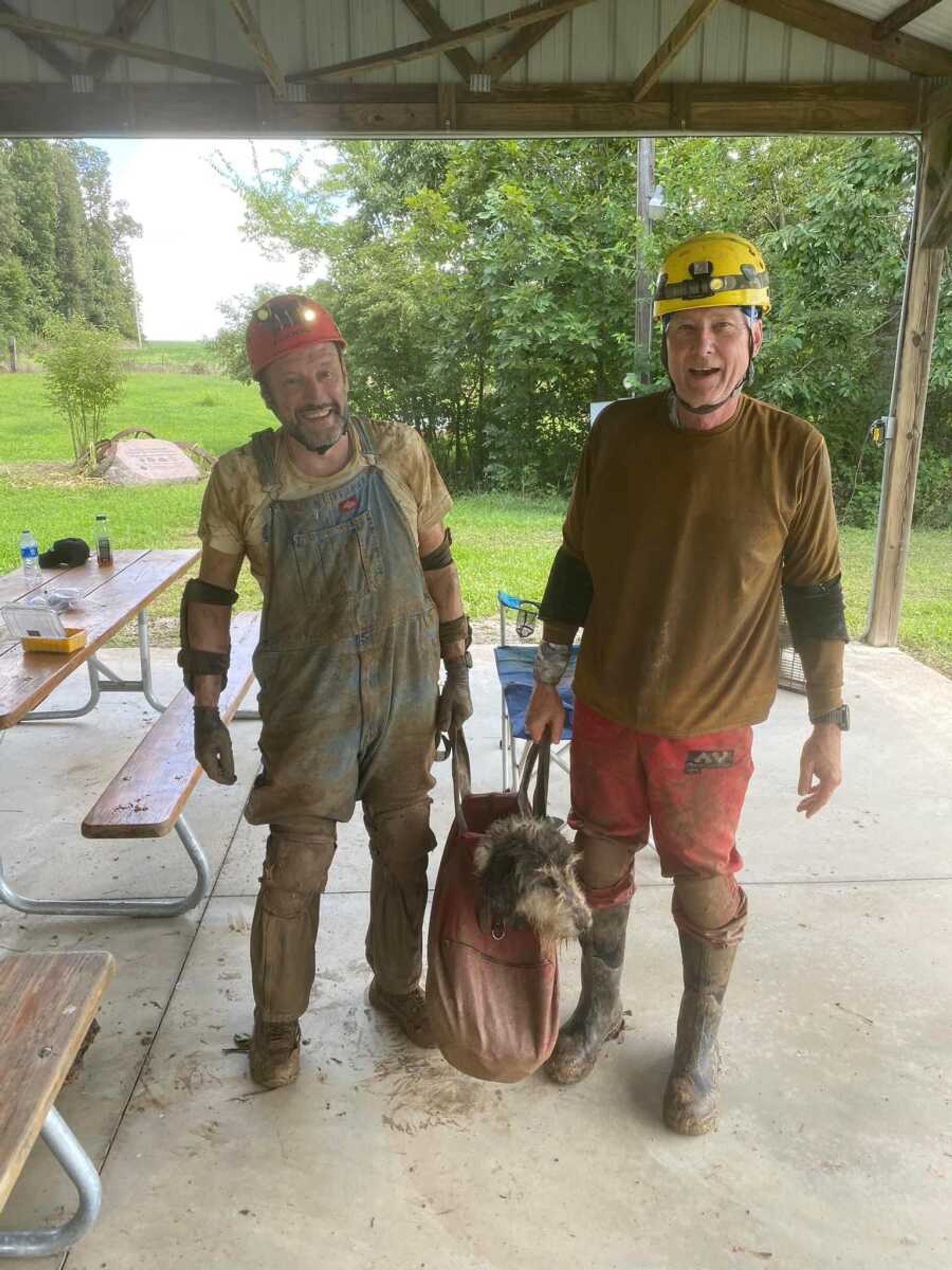 Gerry Keene and Rick Haley holding Abby, who they helped rescue from a cave after she had been missing for nearly two months.