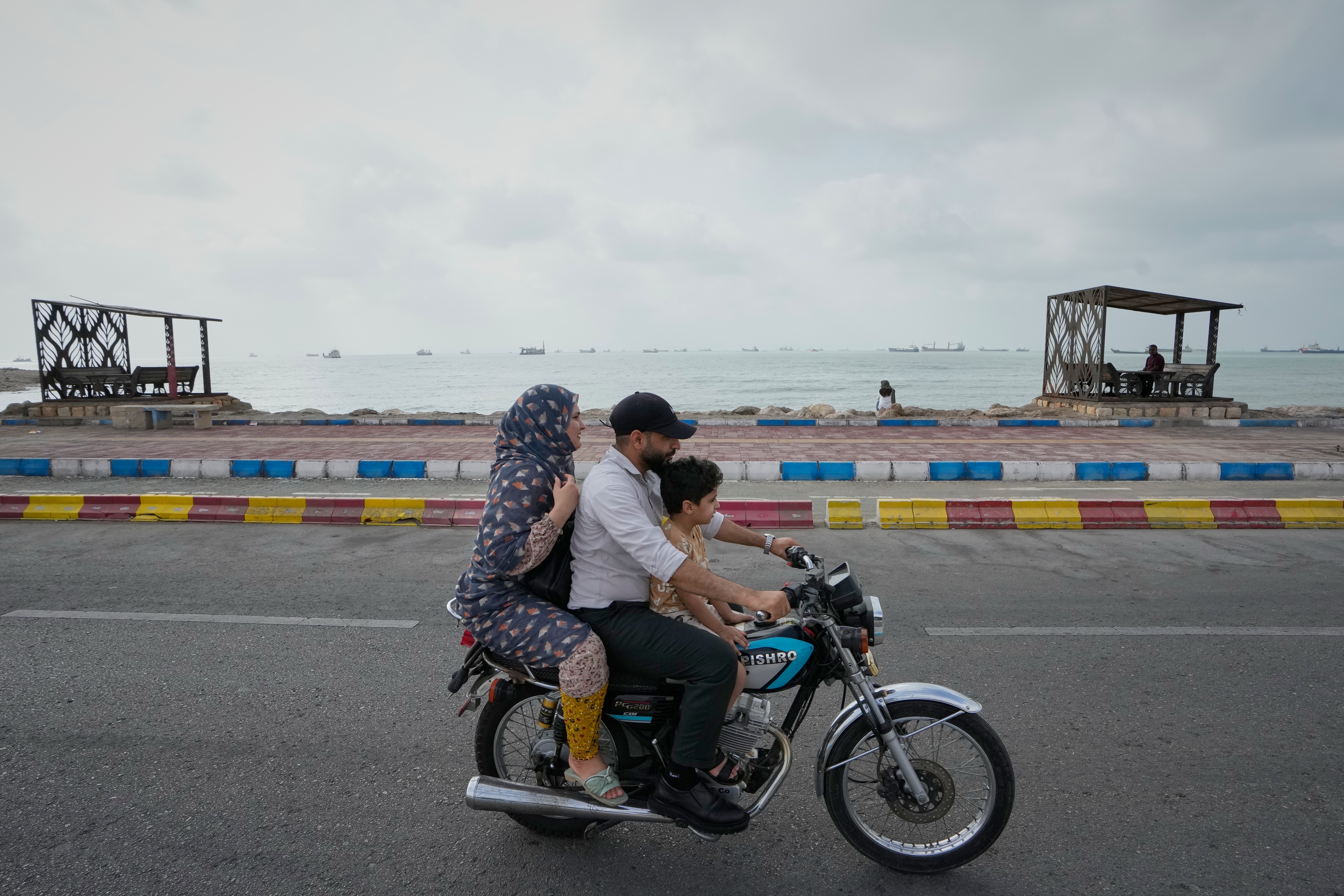 Photos show daily life in Iran on the beach along the Strait