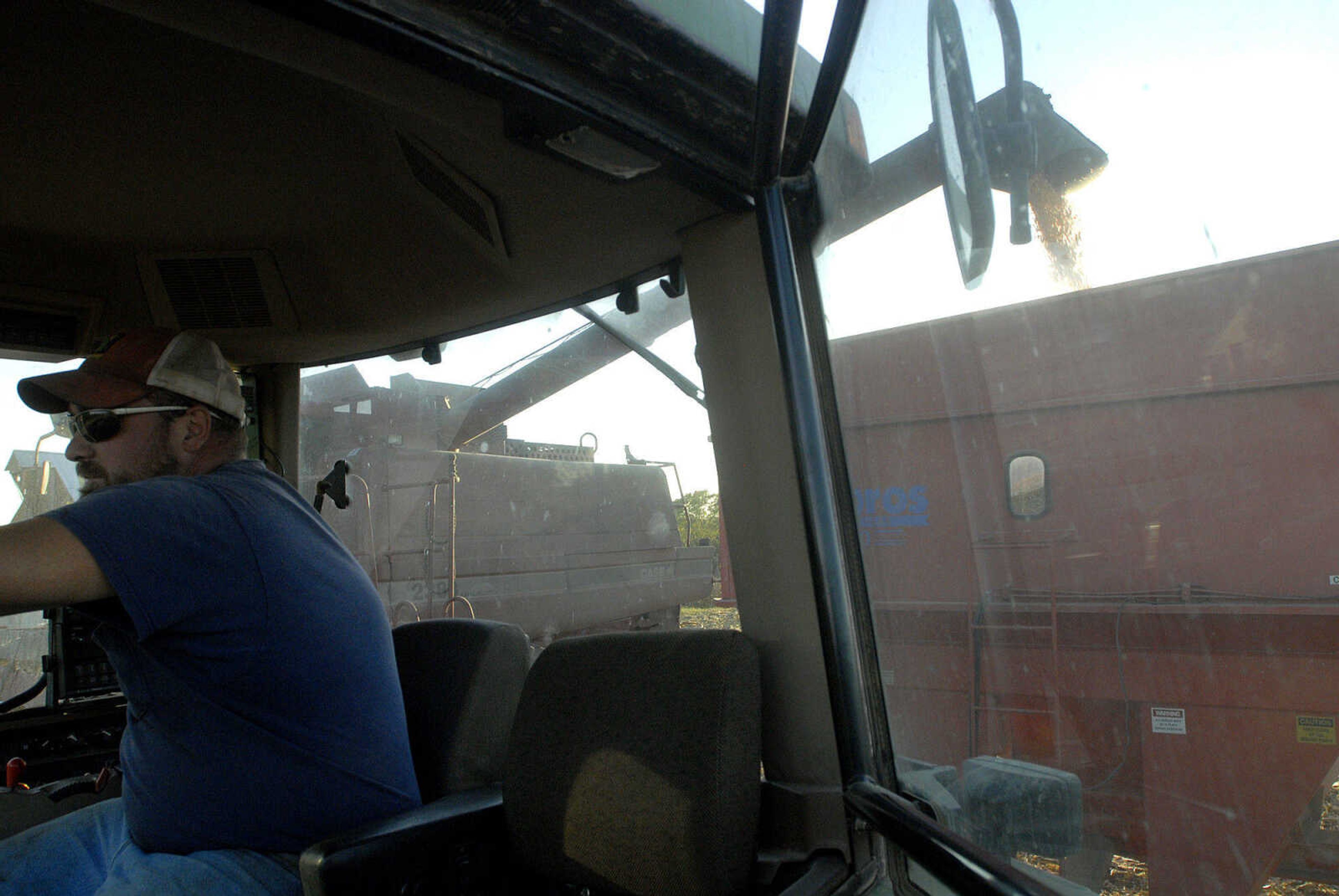 LAURA SIMON ~ lsimon@semissourian.com
Blane Milde waits inside the tractor as his father Frank empties his combine of corn inside grain cart Tuesday, October 4, 2011 near Jackson, Mo.