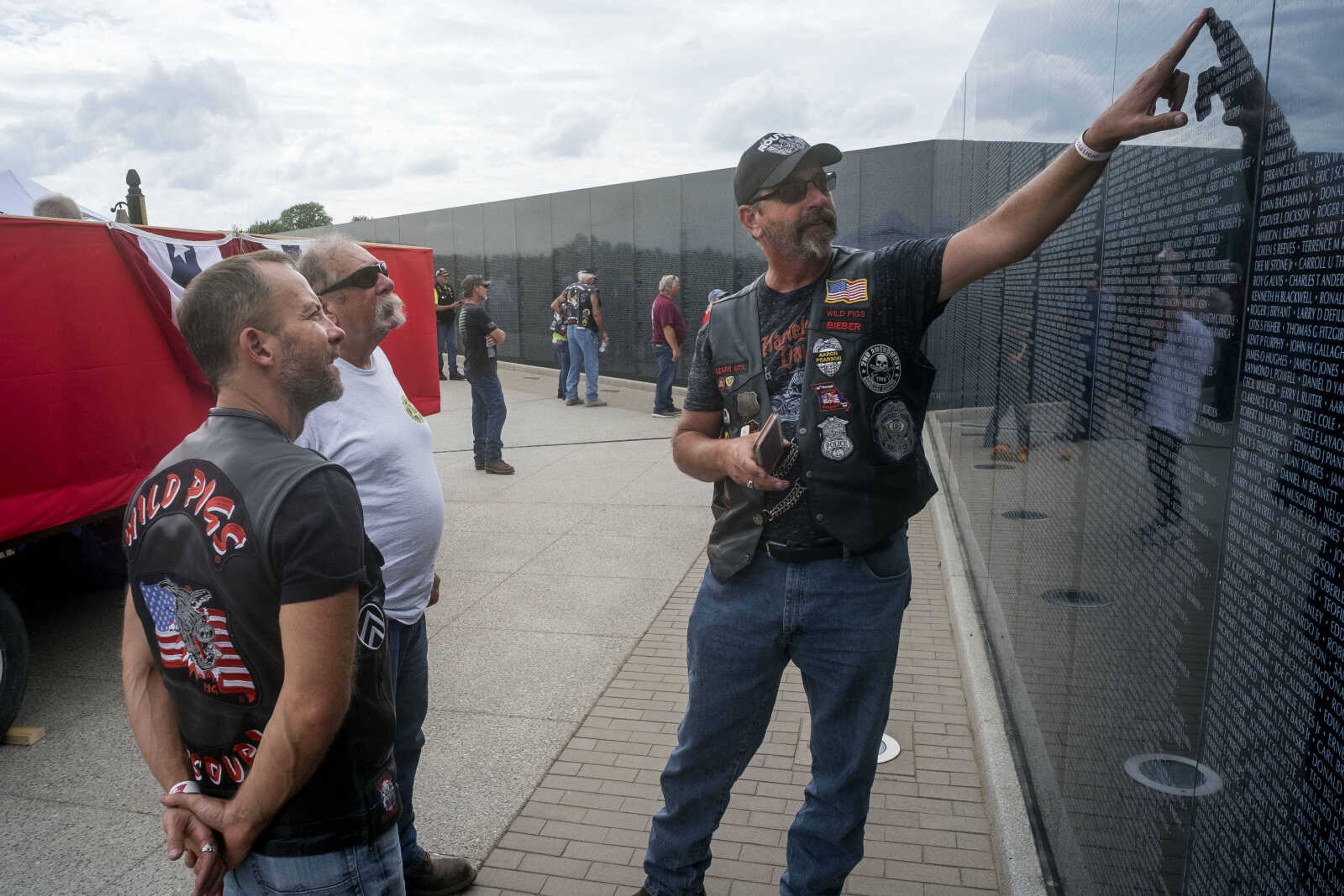 Tom Royal, right, points out the name of his eldest brother, Francis P. Royal, who was killed at 19 in 1966 when Tom was 2, during the first-ever Missouri Vietnam Wall Run Saturday, Sept. 21, 2019, at the Missouri's National Veterans Memorial in Perryville.