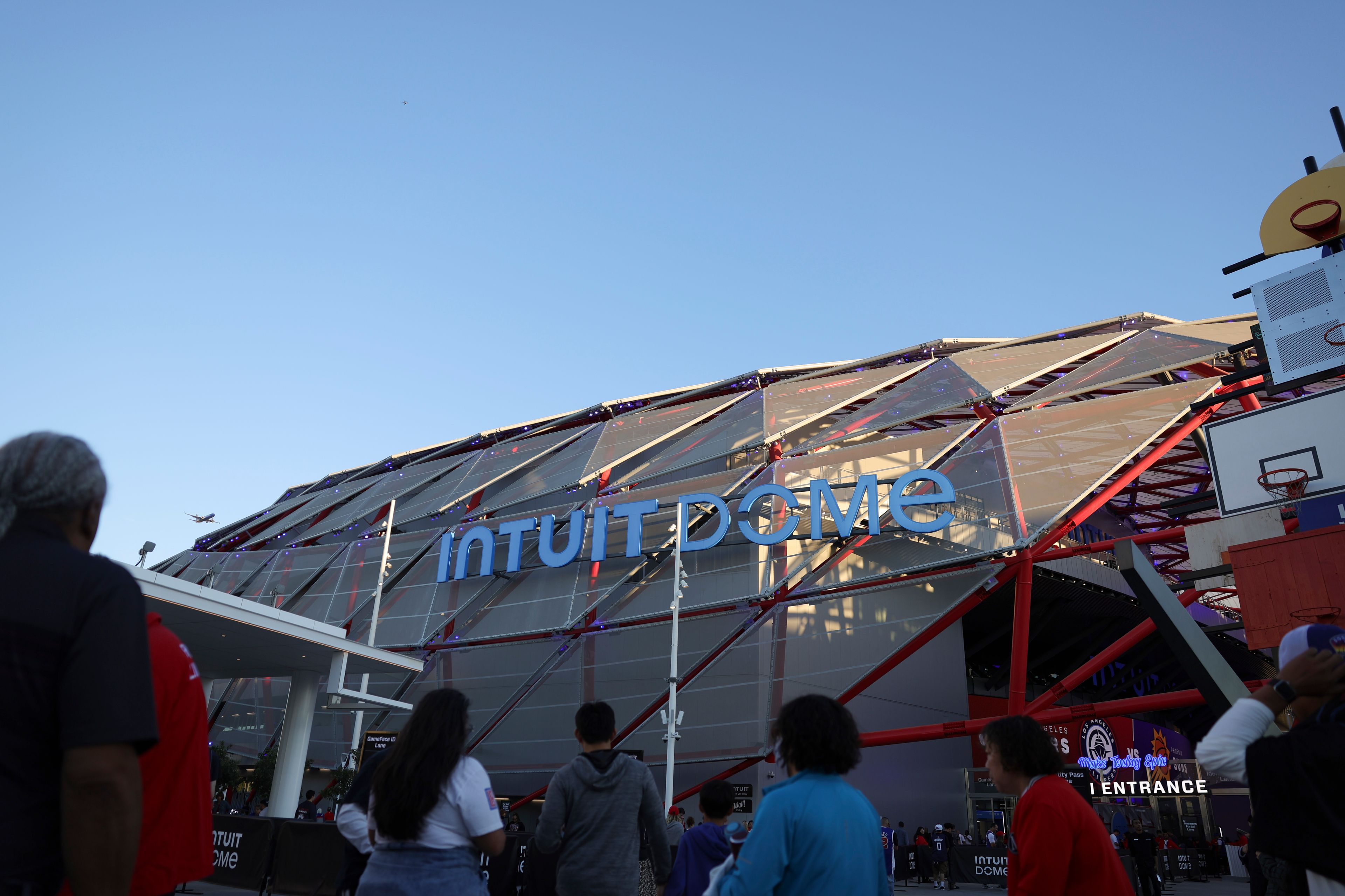 Fans line up at the Intuit Dome before an NBA basketball game between the Los Angeles Clippers and the Phoenix Suns, Wednesday, Oct. 23, 2024, in Inglewood, Calif. (AP Photo/Ryan Sun)