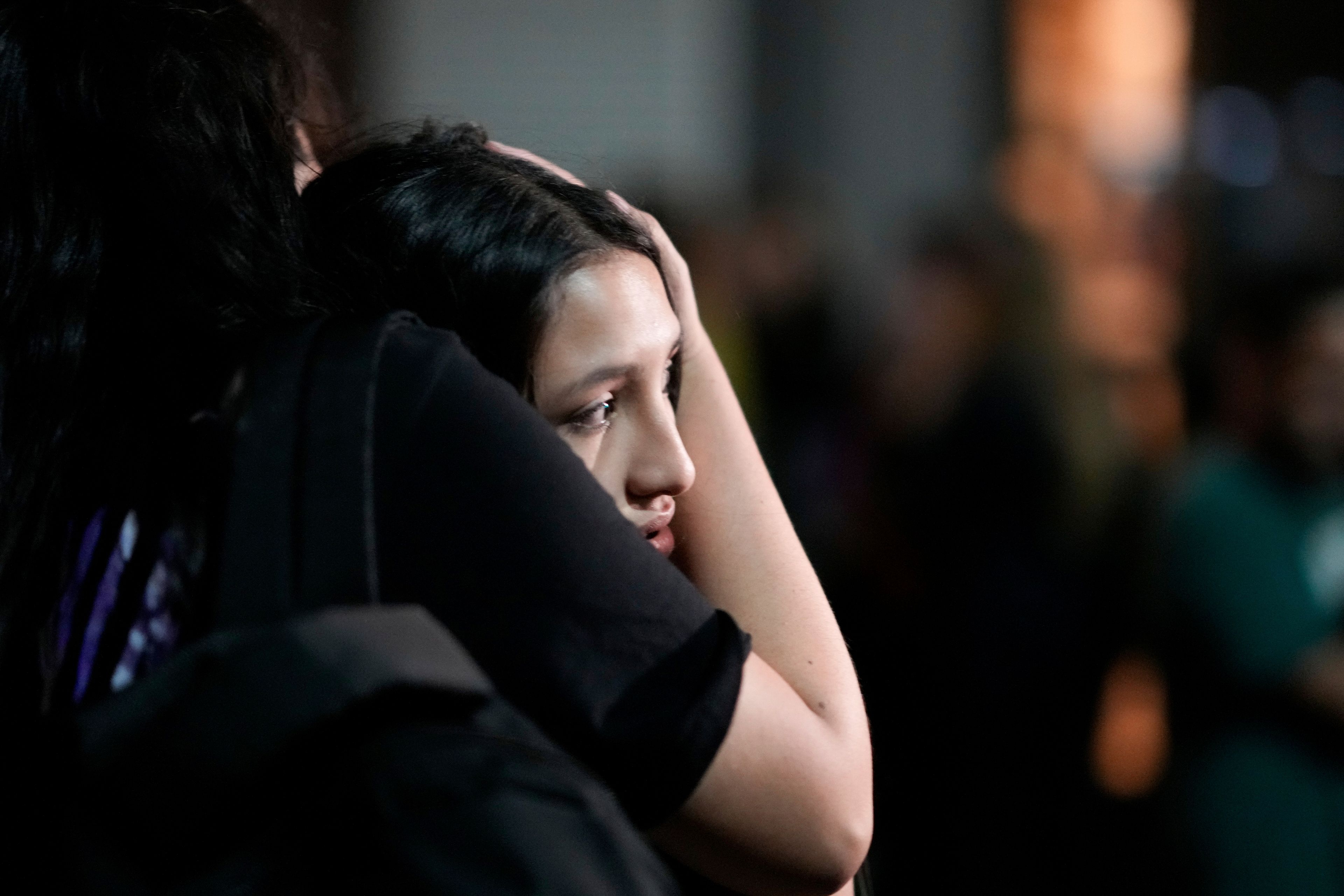 People embrace outside the hotel where former One Direction singer Liam Payne was found dead after he fell from a balcony in Buenos Aires, Argentina, Wednesday, Oct. 16, 2024. (AP Photo/Natacha Pisarenko)