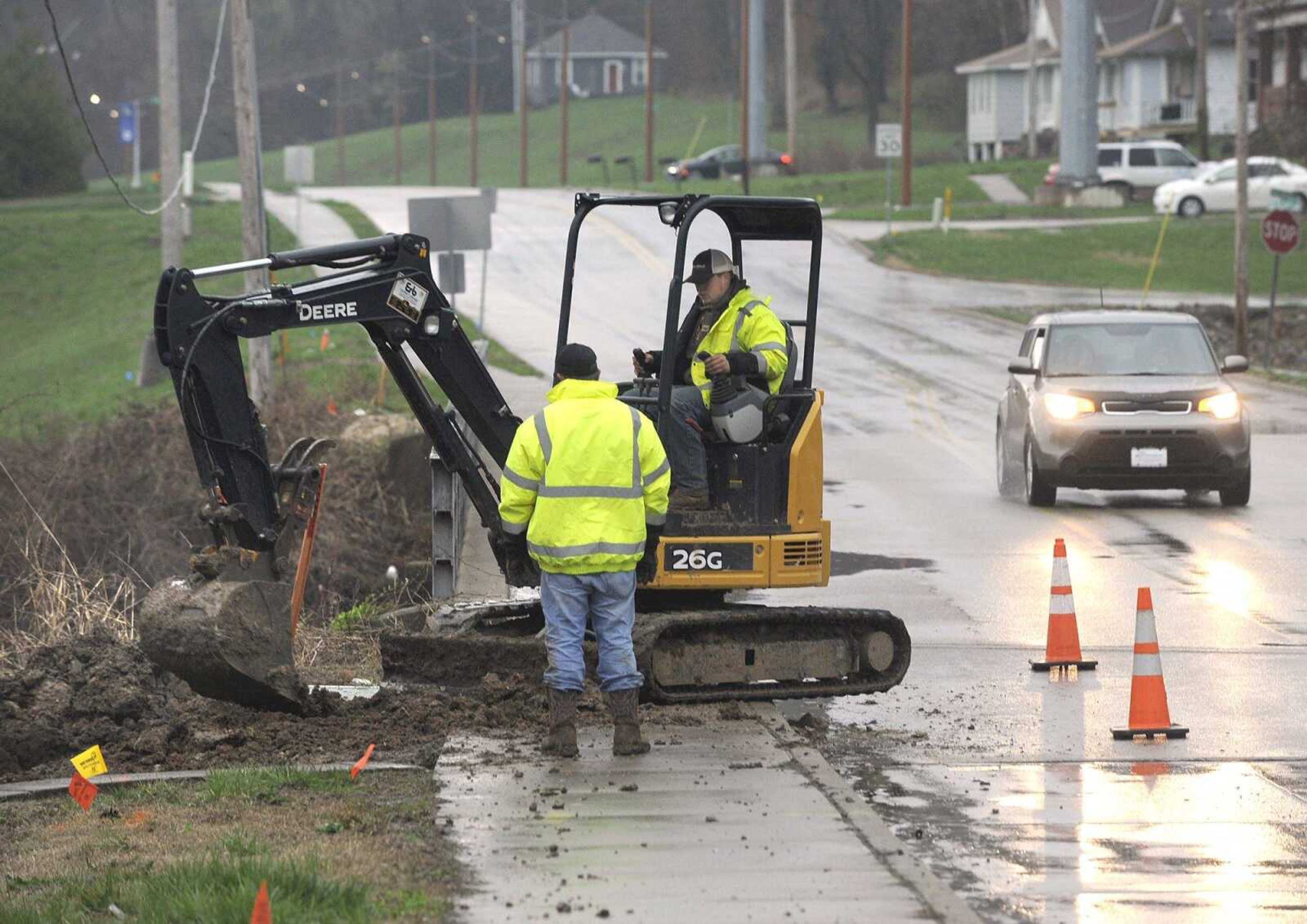 A crew installs fiber-optic cable for Charter Communications on Tuesday over Sloan Creek along Big Bend Road in Cape Girardeau. Construction of a new bridge over the Mississippi River tributary could start next month. It will be funded by the city's Transportation Trust Fund 5 sales tax approved by voters in 2015. During the four-month-long construction period, the old Main Street floodgate and bridge will be reopened for local traffic.