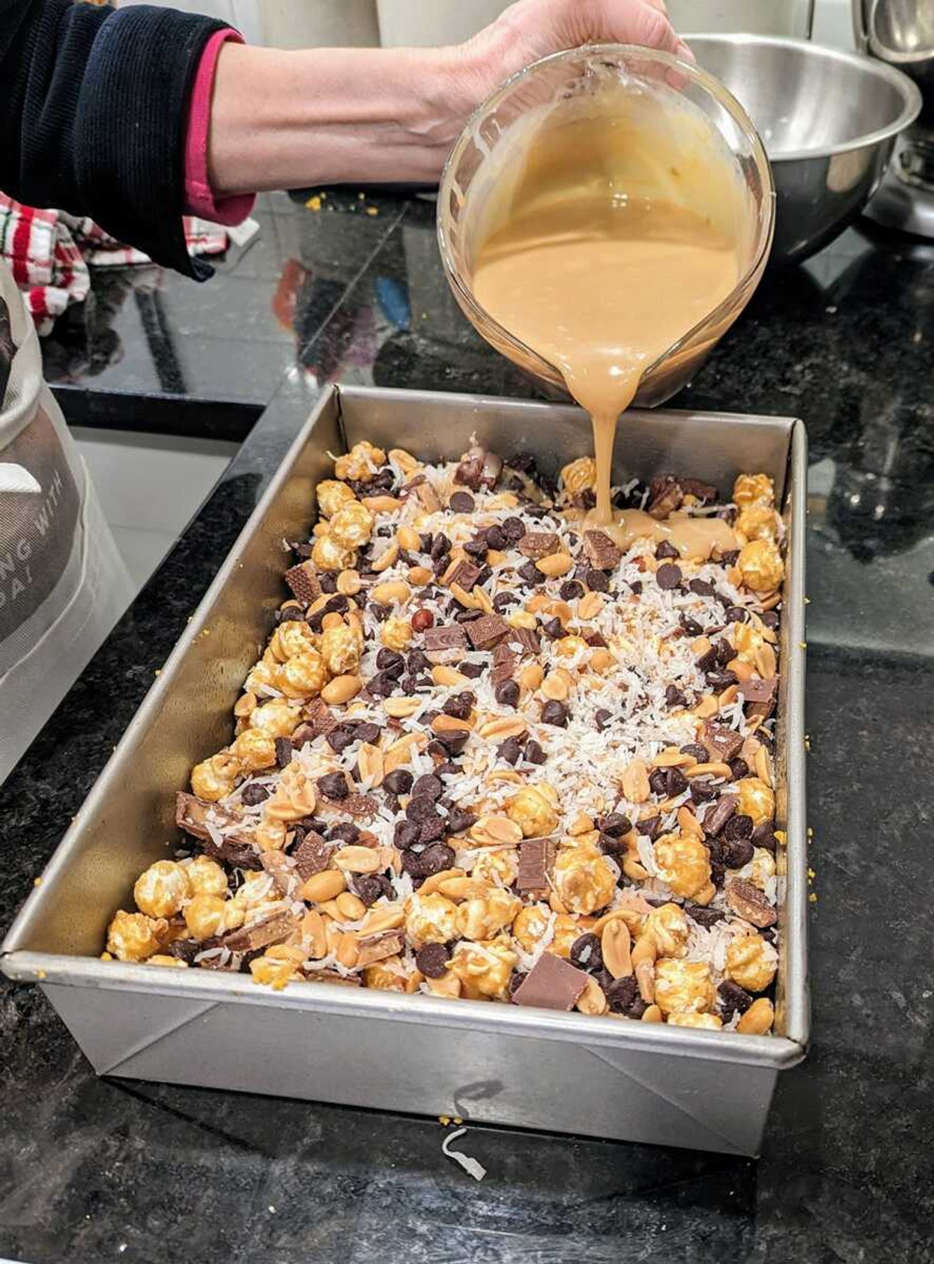 The magic ingredient in Hello Dolly! Bars is sweetened condensed milk, here combined with caramelized white chocolate and poured over the other ingredients to make a showstopper version of the classic holiday treat.